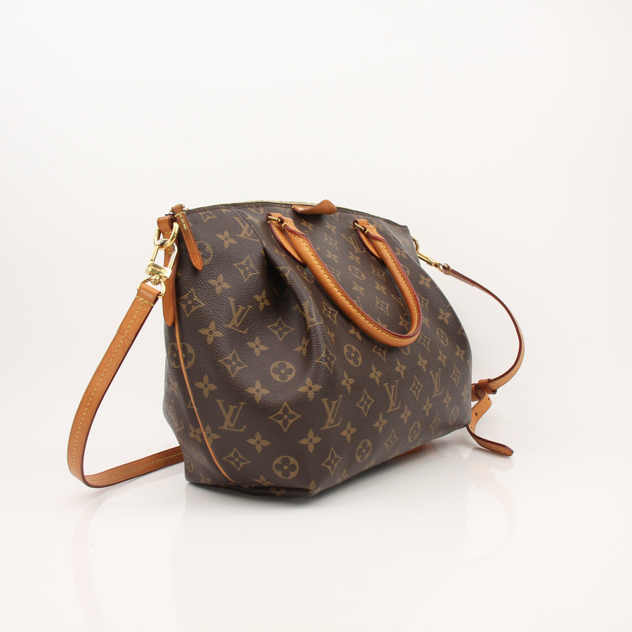 Brown handbag with gold accents on a white background