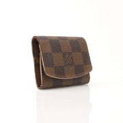 Louis Vuitton Damier Ebene key holder pouch from Gold & Beyond, featuring checkered pattern and metal key hooks.