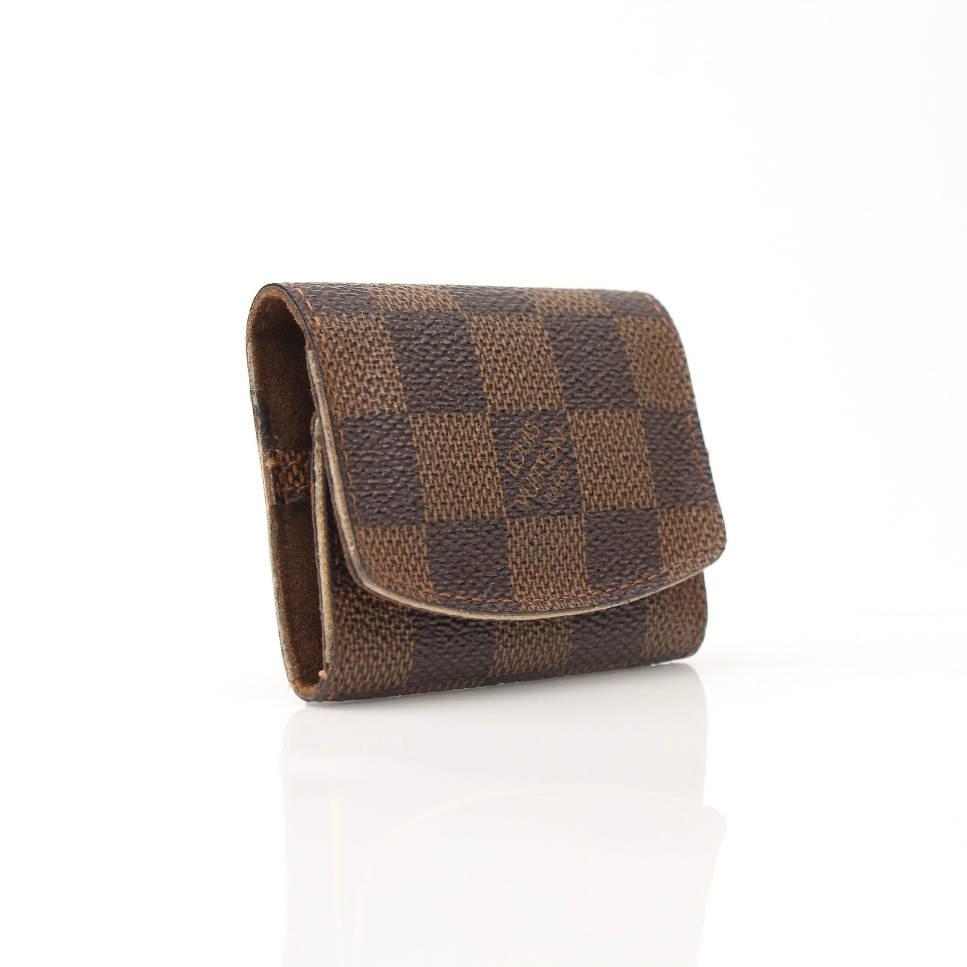 Louis Vuitton Damier Ebene key holder pouch from Gold & Beyond, featuring checkered pattern and metal key hooks.