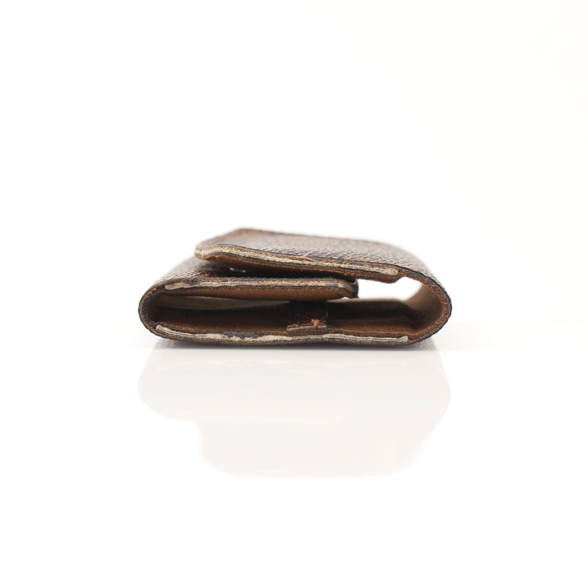 Louis Vuitton Damier Ebene key holder pouch with gold hardware and multiple key rings, designed for accessories and organization.