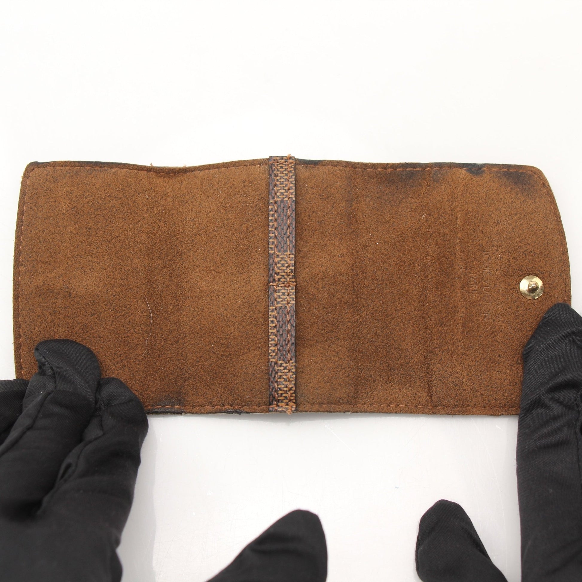 Louis Vuitton Damier Ebene key holder pouch with gold hardware and multiple key rings, designed for accessories and organization.