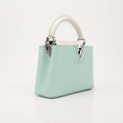Louis Vuitton Capucines handbag with leather and metal accents, showcasing elegant design and craftsmanship.