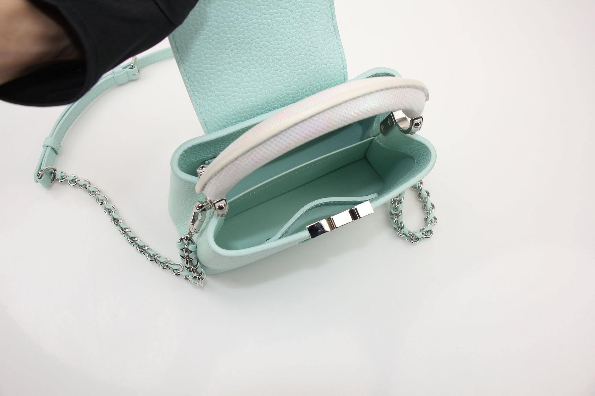 Louis Vuitton Capucines handbag with leather exterior and gold hardware, showcasing elegant design and craftsmanship.