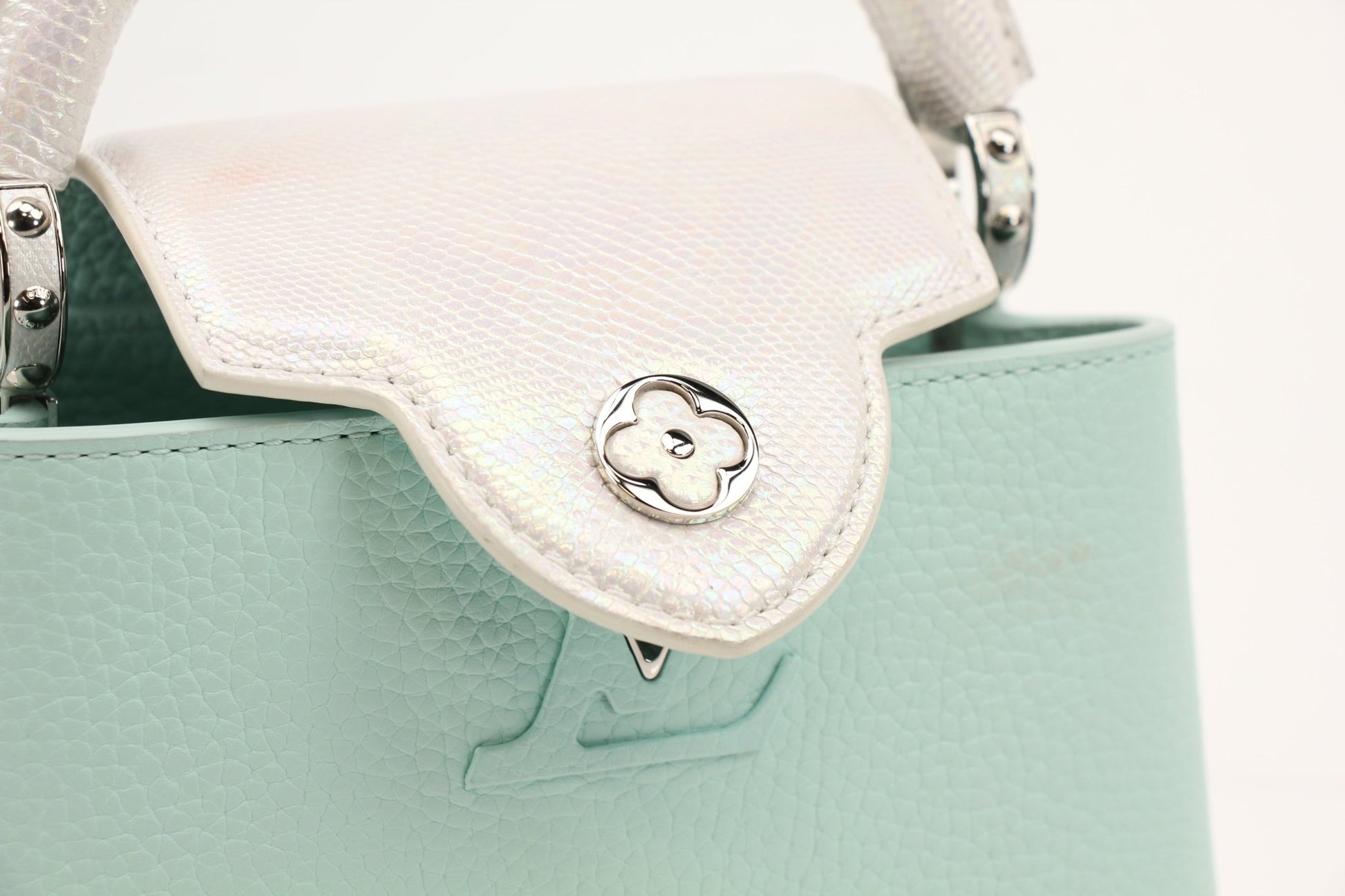Louis Vuitton Capucines handbag with leather exterior and gold hardware, featuring top handles and sleek design.