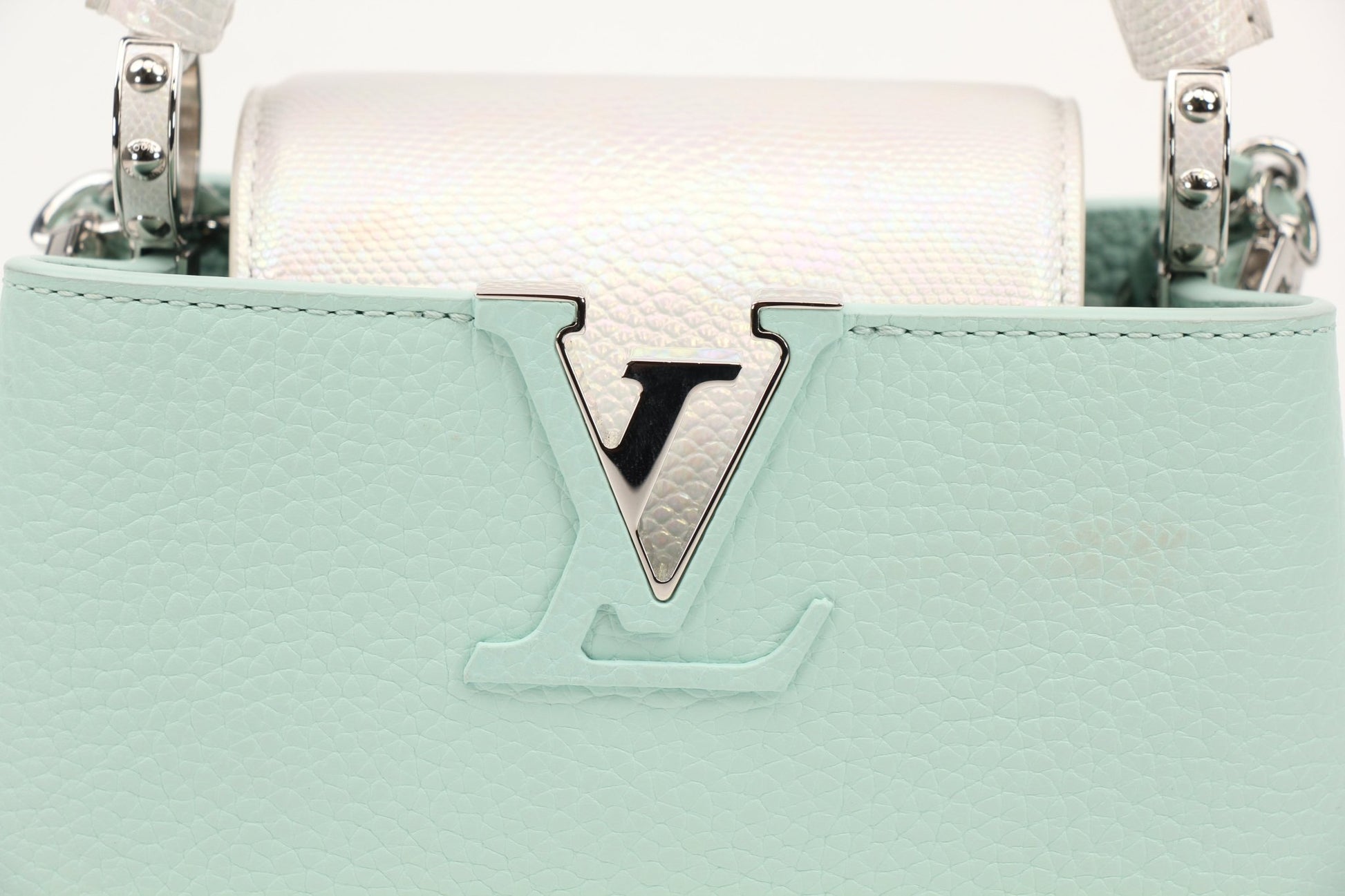 Louis Vuitton Capucines handbag with leather exterior and gold hardware, displayed on a neutral background.