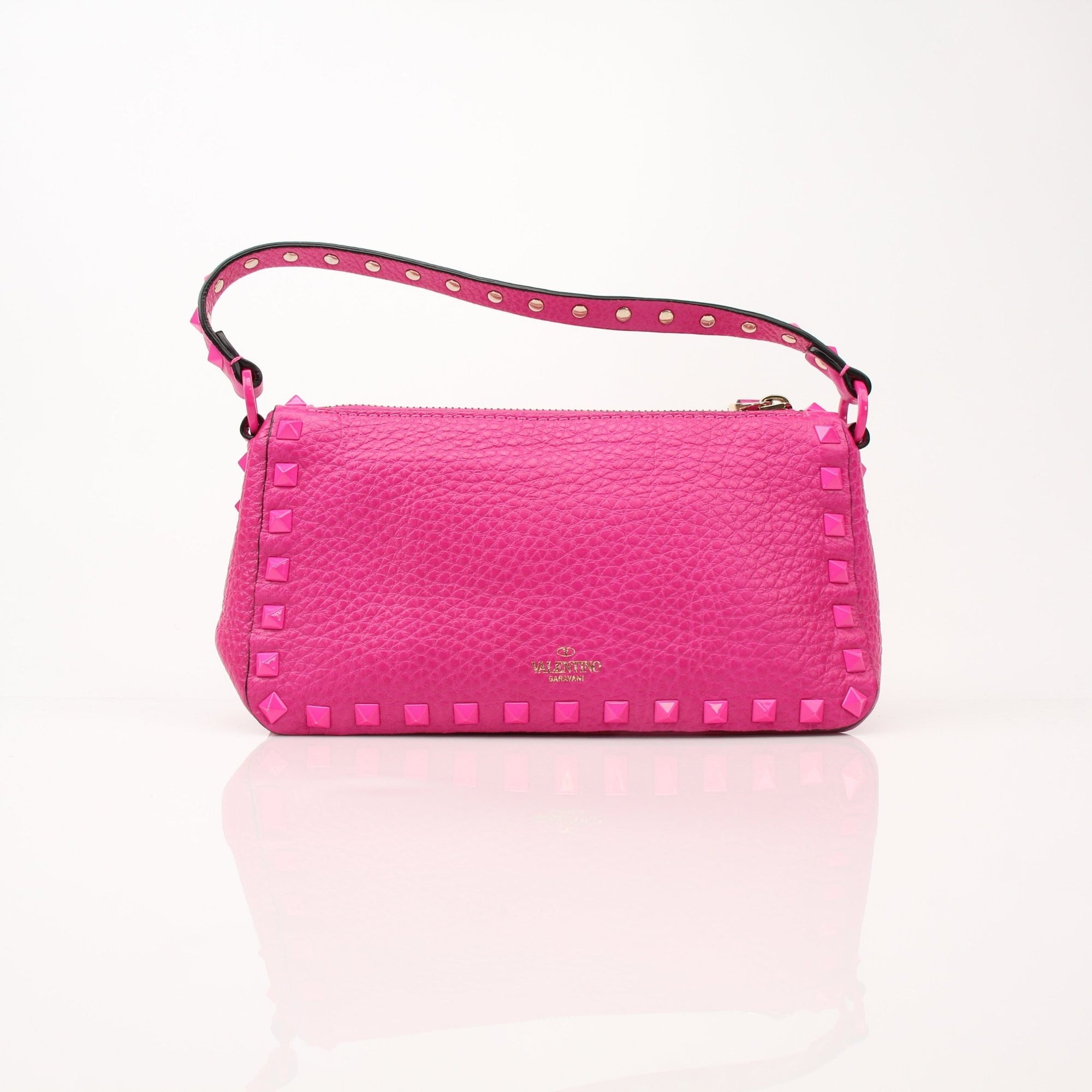Valentino Fuchsia Pink Rockstud Flip Lock Shoulder Bag with gold hardware and adjustable shoulder strap on a plain background.