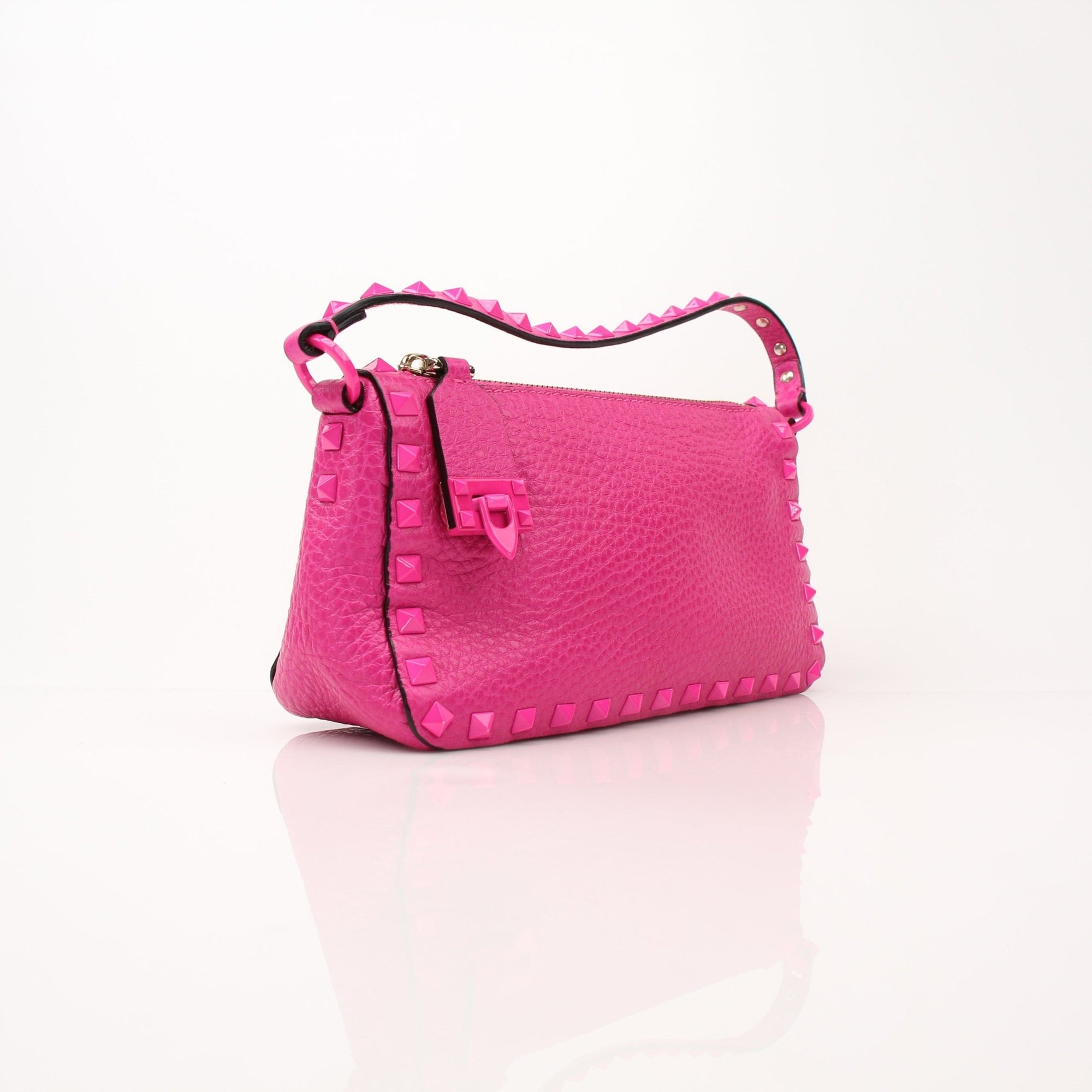 Fuchsia pink Valentino Rockstud flip lock shoulder bag with gold hardware and studded detailing, designed by Gold & Beyond.
