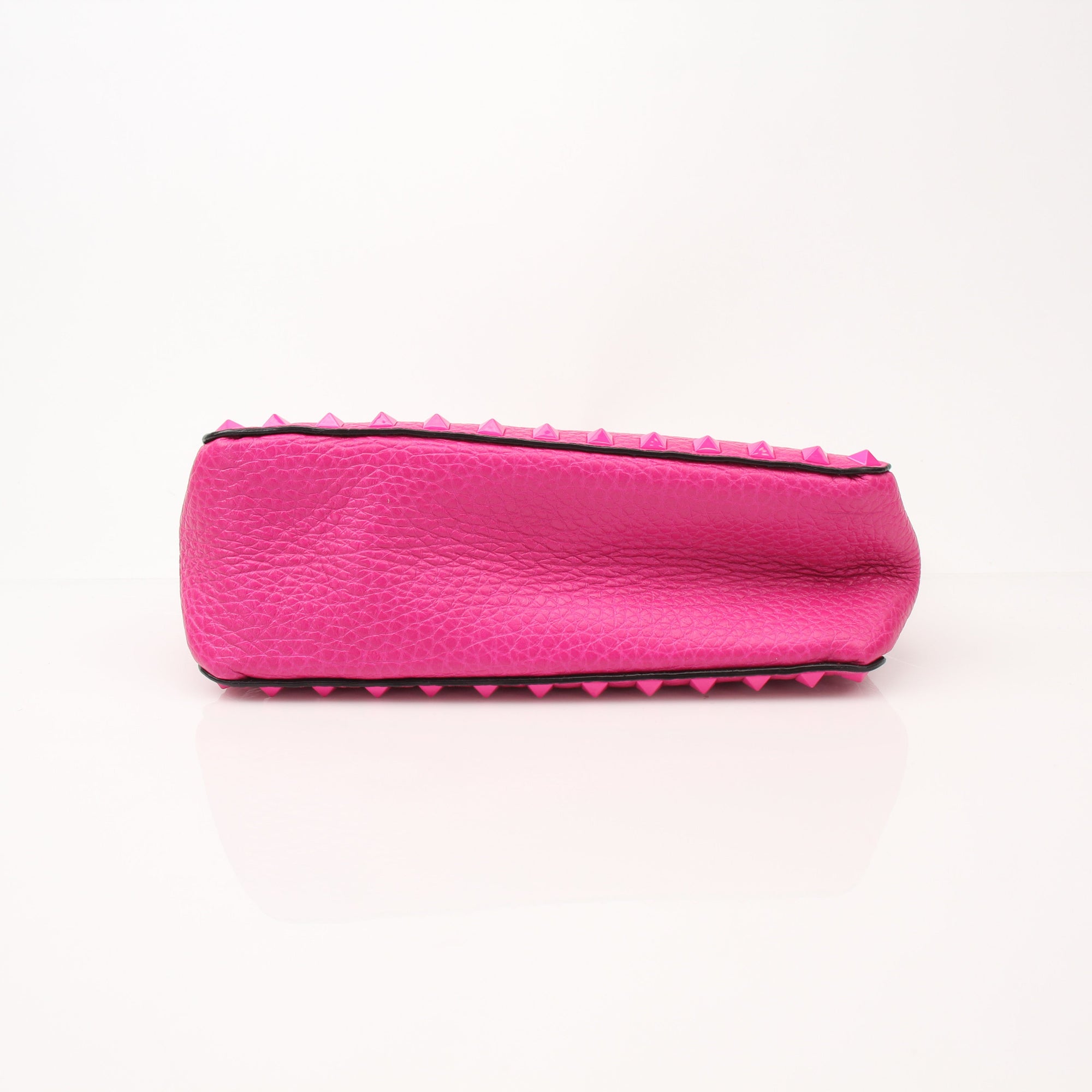 Fuchsia pink Valentino Rockstud flip lock shoulder handbag with gold accents and adjustable shoulder strap.