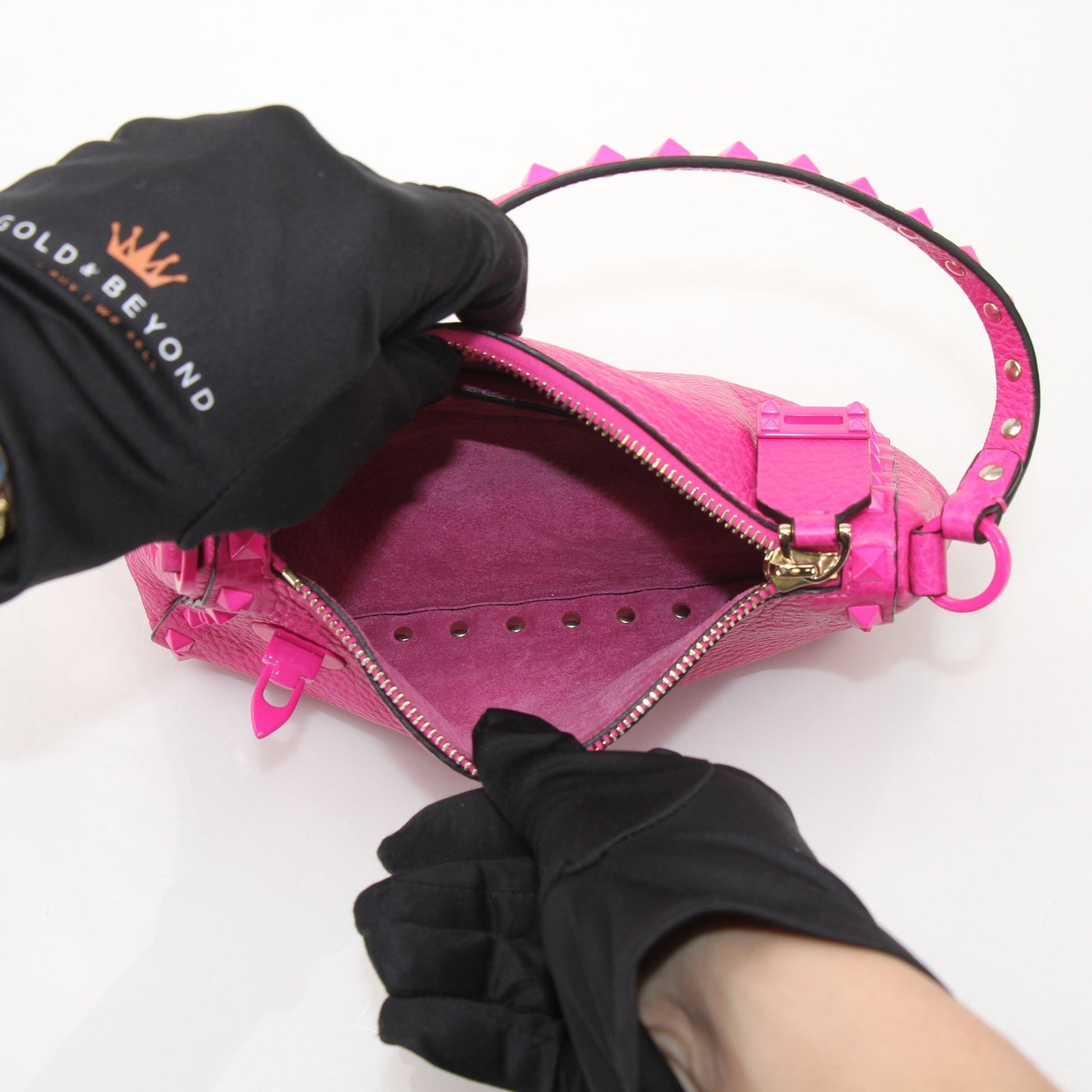 Fuchsia pink Valentino Rockstud flip lock shoulder handbag with gold hardware and adjustable strap, stylish and luxurious design.