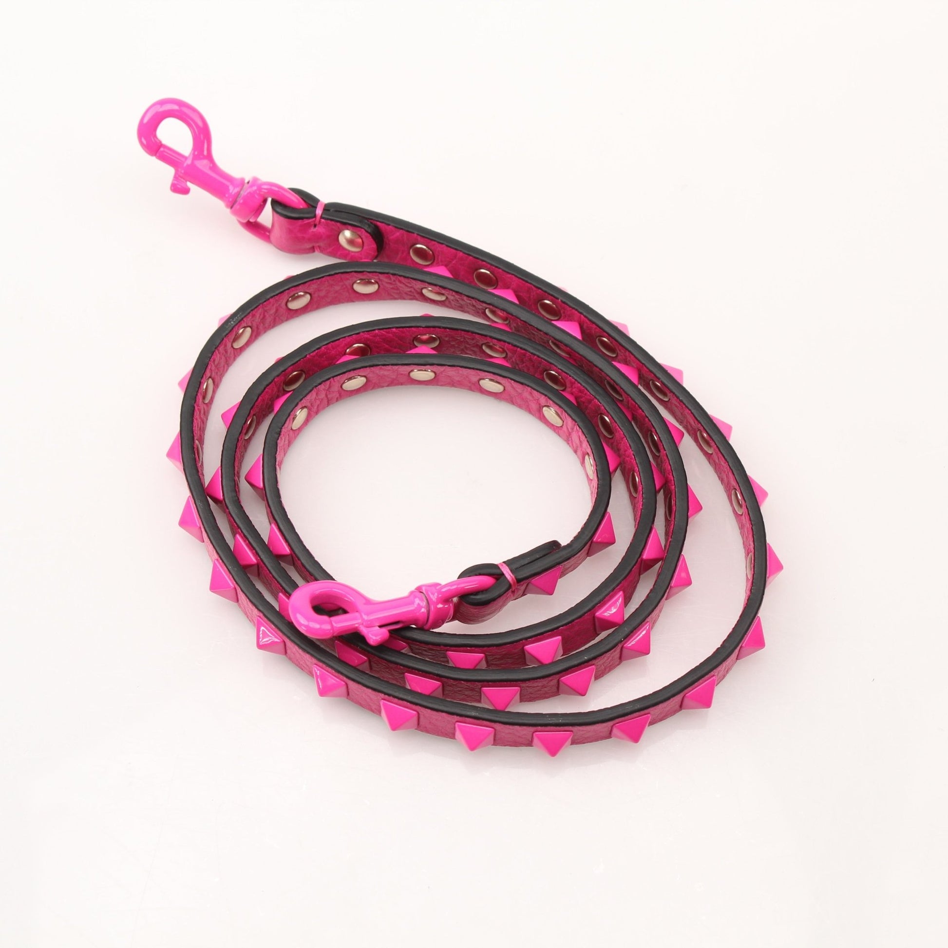 Fuchsia pink Valentino Rockstud flip lock shoulder handbag with gold accents and adjustable strap.