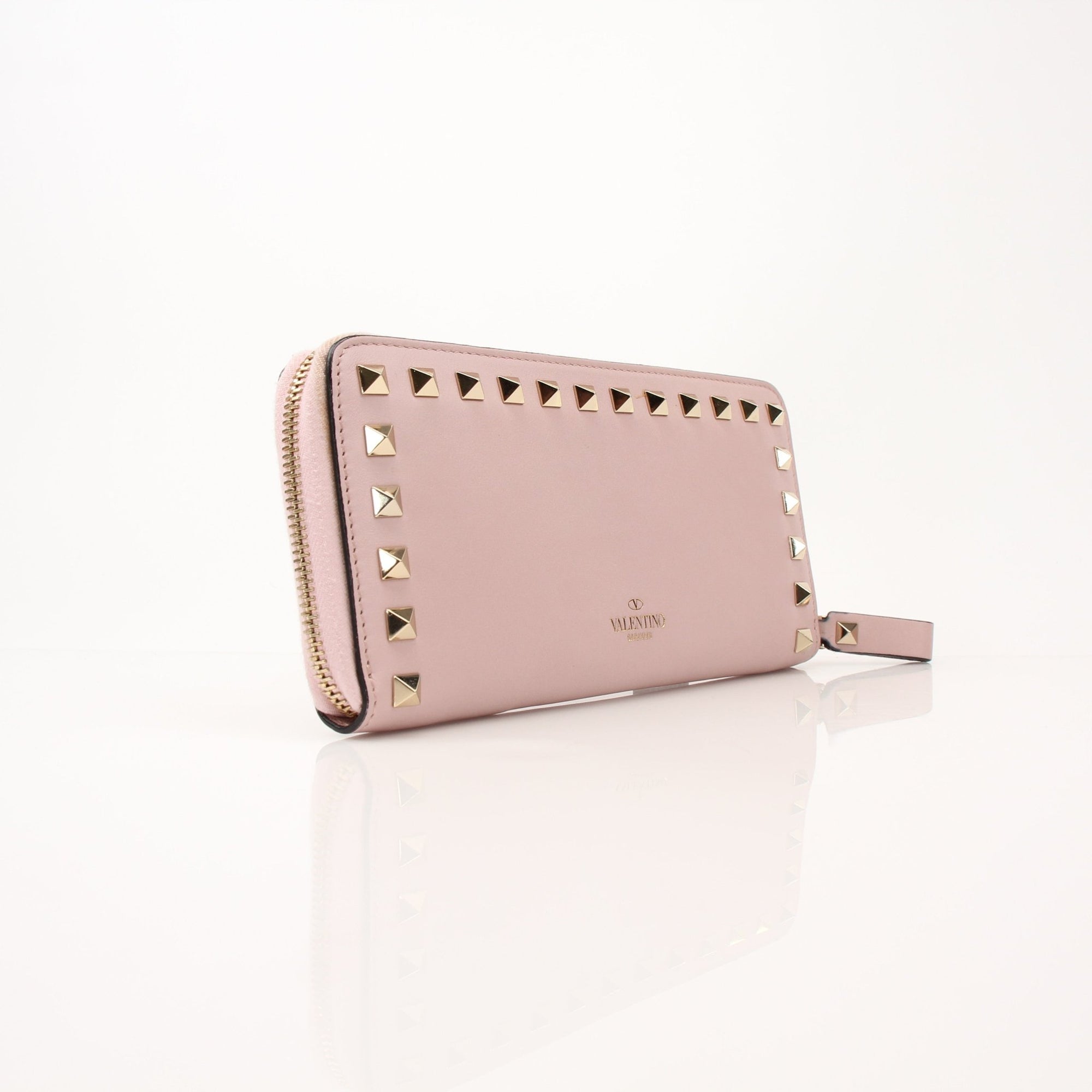 Gold & Beyond Valentino Pink Rockstud zip around wallet with gold hardware, featuring a sleek design and signature Rockstud accents.