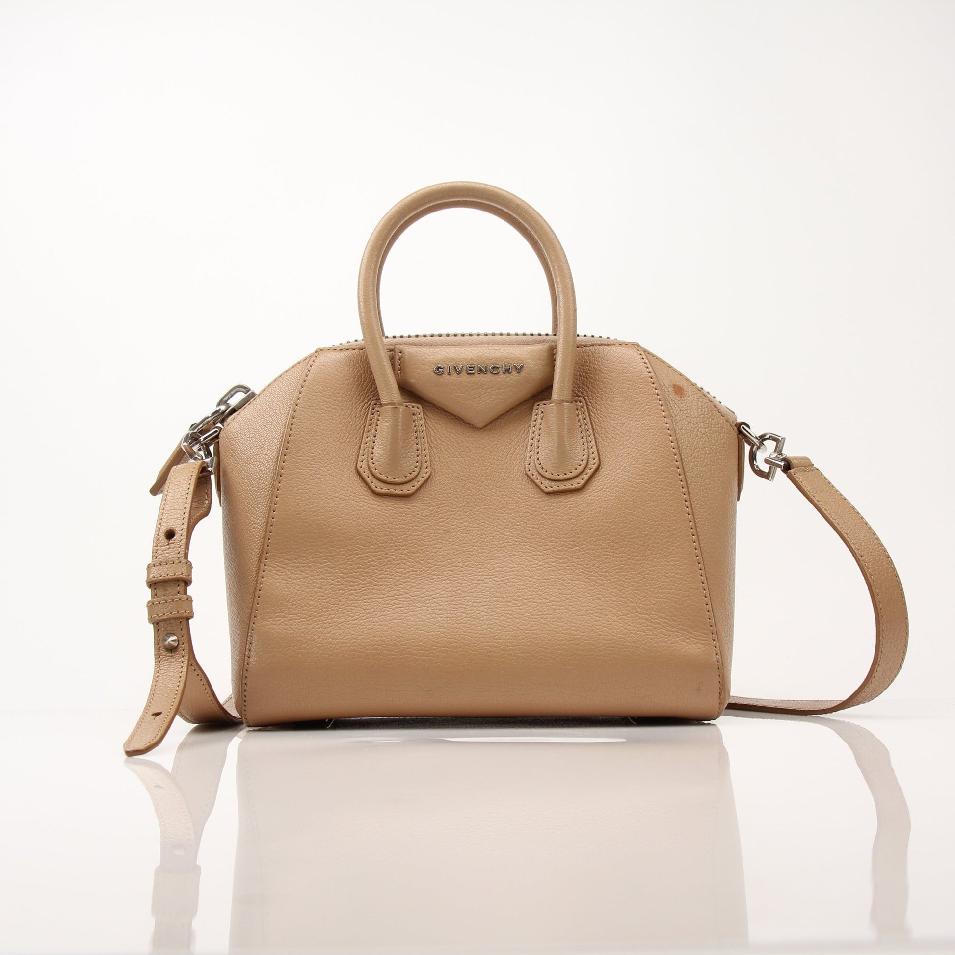 Givenchy brown Antigona mini top handle handbag with gold hardware, showcasing its stylish leather design and compact shape.