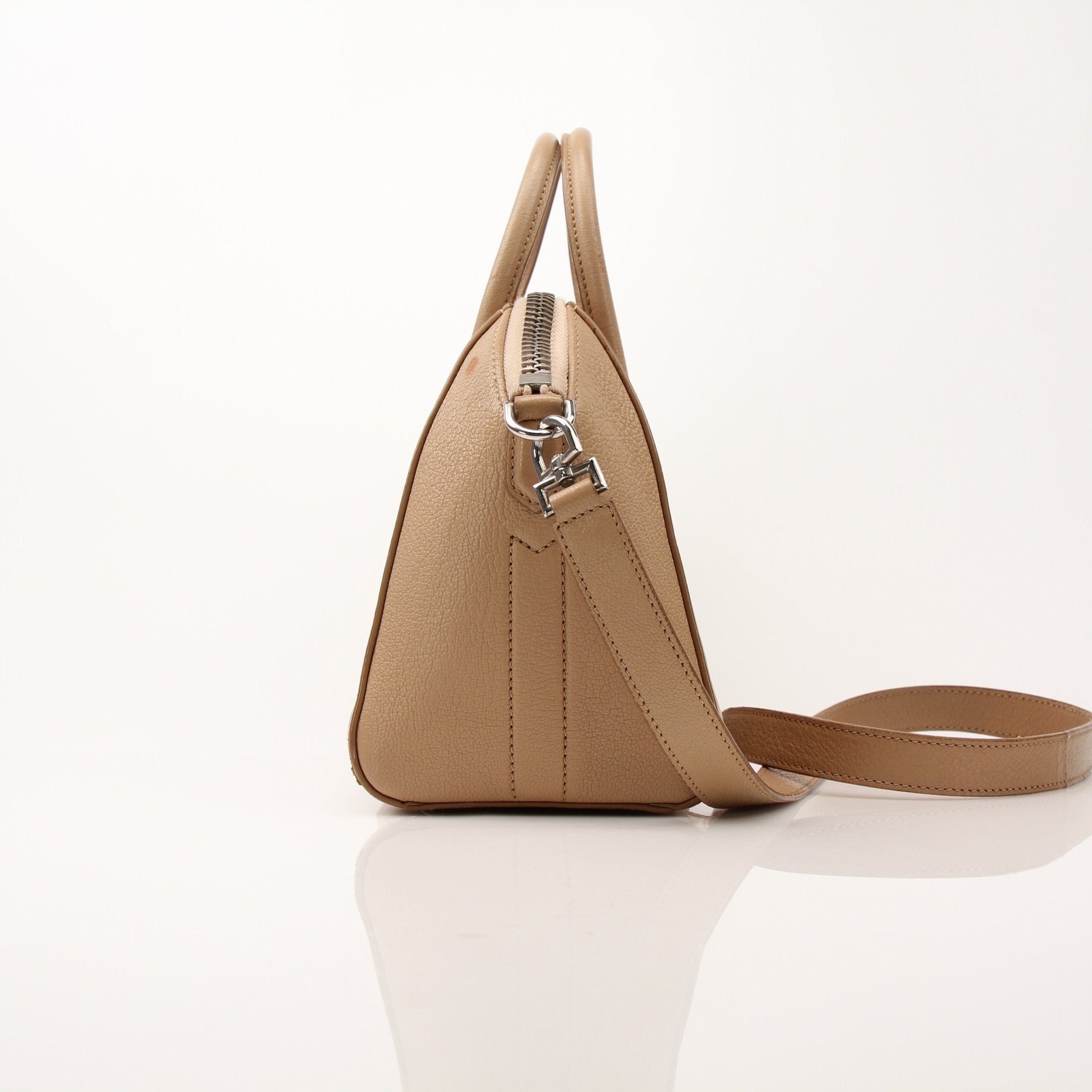 Givenchy brown Antigona mini handbag with top handle, showcasing its stylish leather design and compact shape.