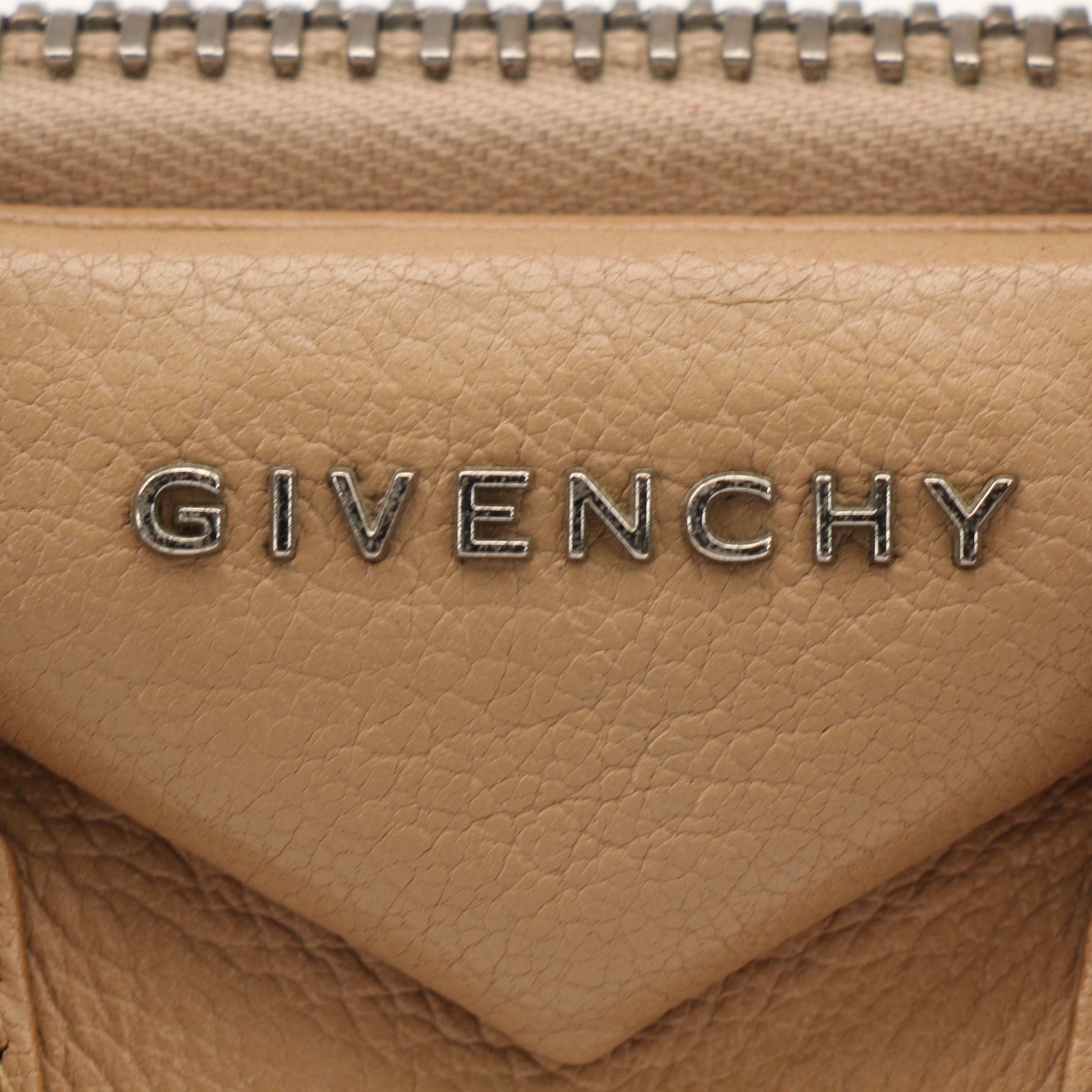 Givenchy brown Antigona mini handbag with top handle, featuring structured design and gold-tone hardware.