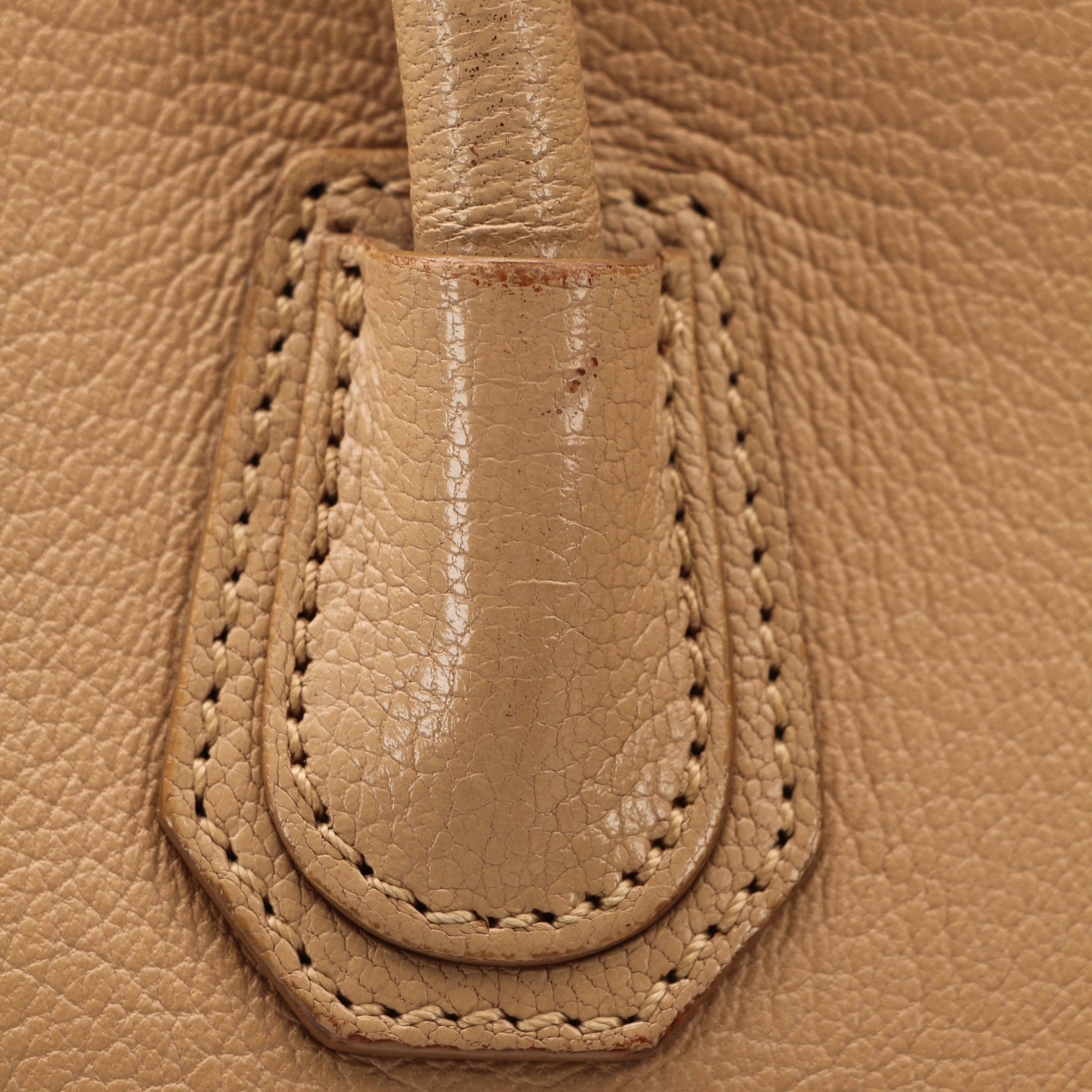 Givenchy brown Antigona mini handbag with top handle, gold hardware, and sleek leather design.
