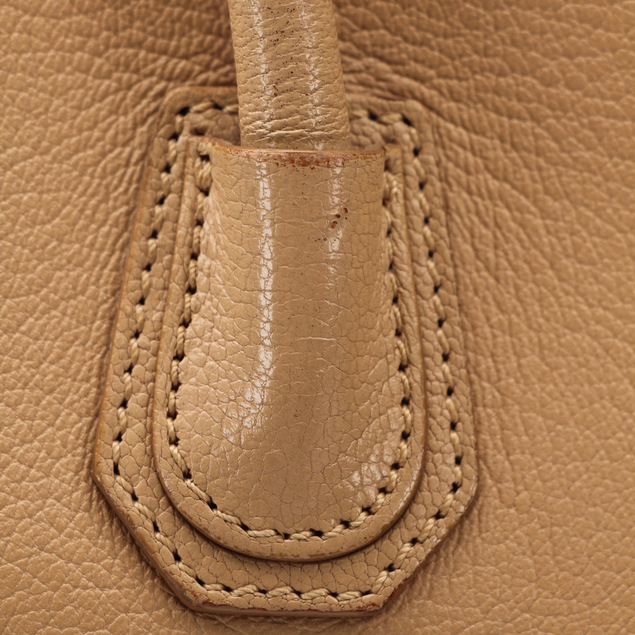 Givenchy brown Antigona mini handbag with top handle, gold hardware, and sleek leather design.