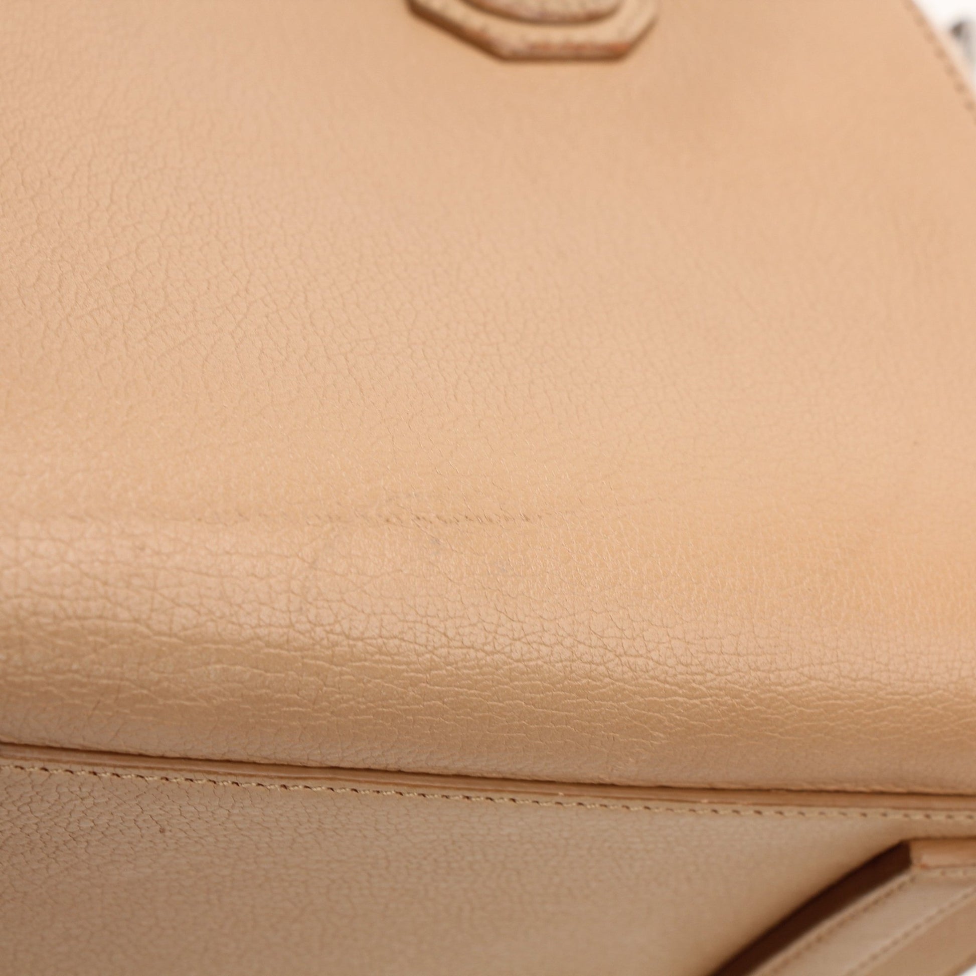 Givenchy brown Antigona mini handbag with top handle, showcasing sleek design and gold-tone hardware.