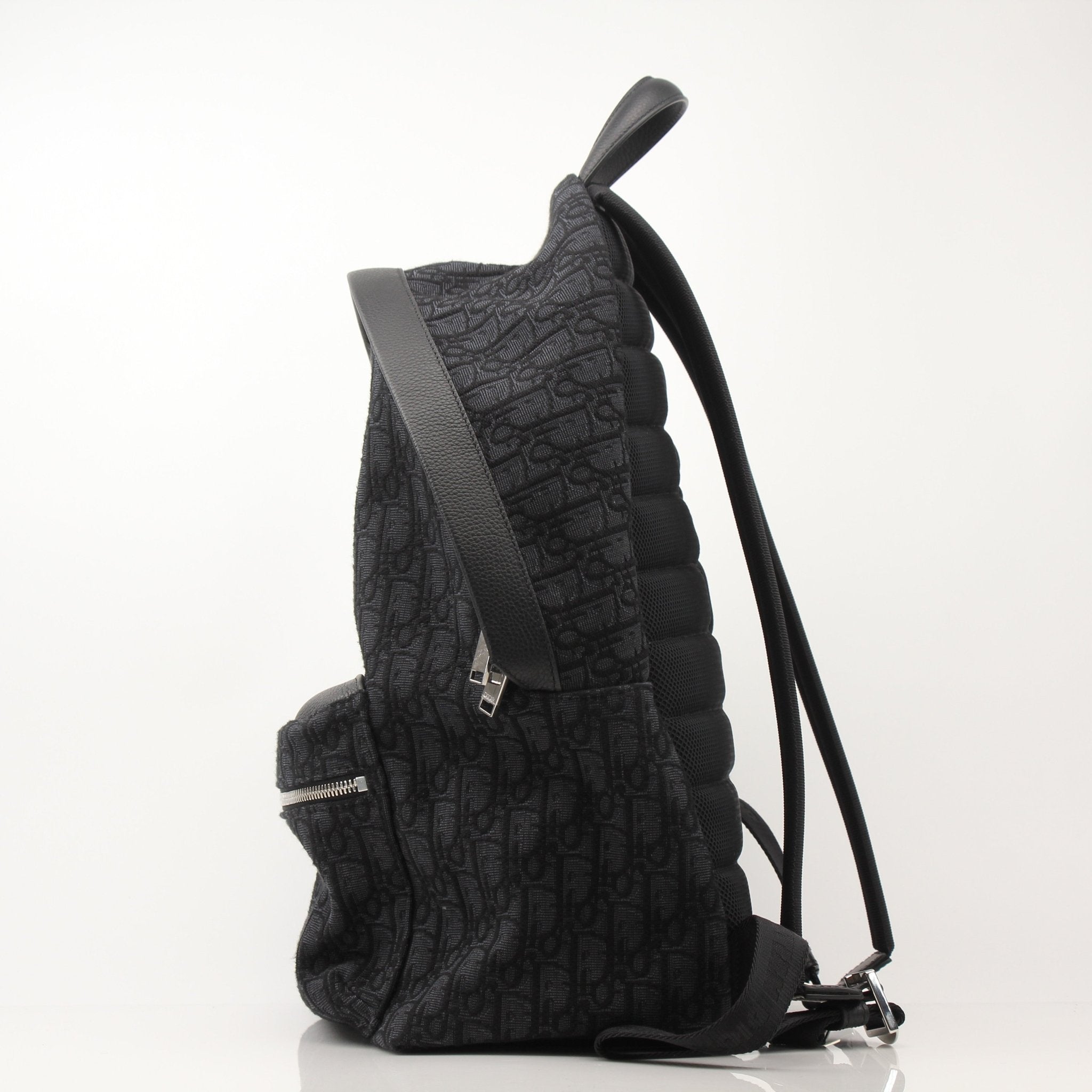 Christian Dior Oblique canvas backpack with adjustable straps and gold-tone hardware, ideal for travel and everyday use.