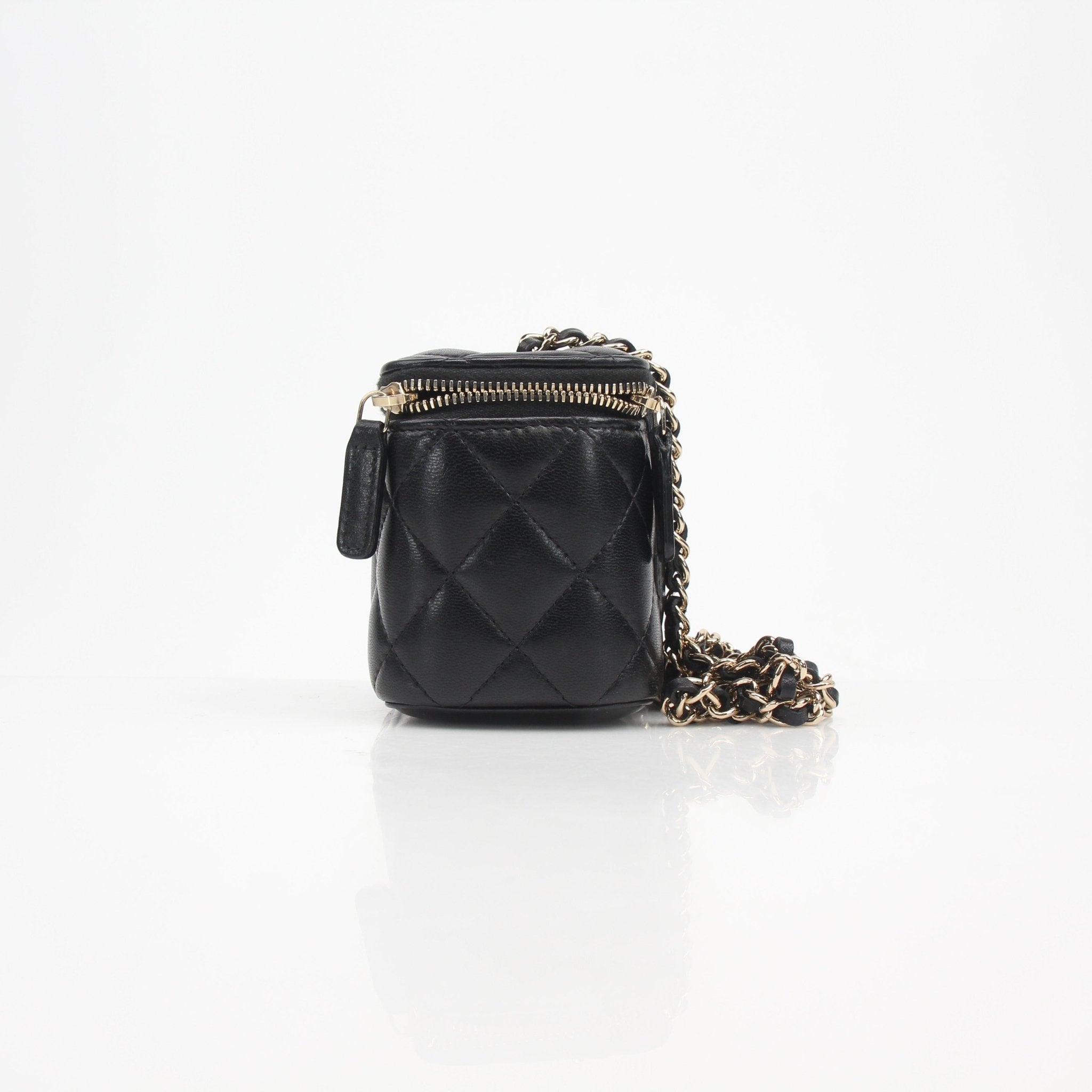 Gold & Beyond Chanel mini quilted lambskin vanity case with chain, featuring a compact design and luxurious texture.