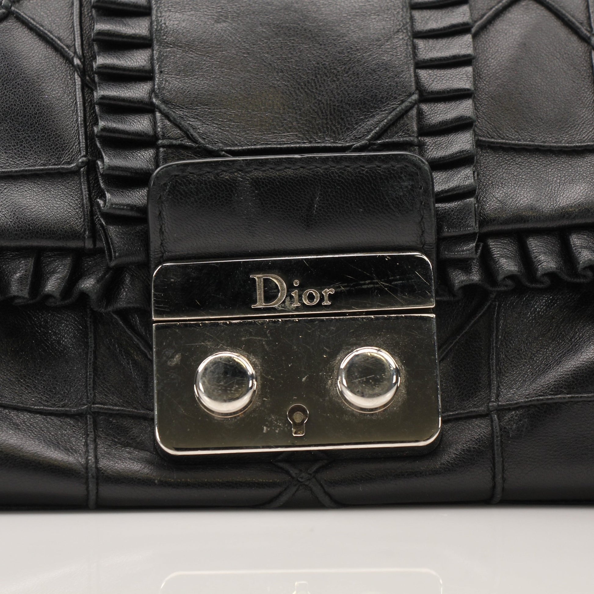 Christian Dior New Lock Ruffle Bag handbag with gold-tone hardware and ruffle detailing, stylish accessory for elegant occasions.