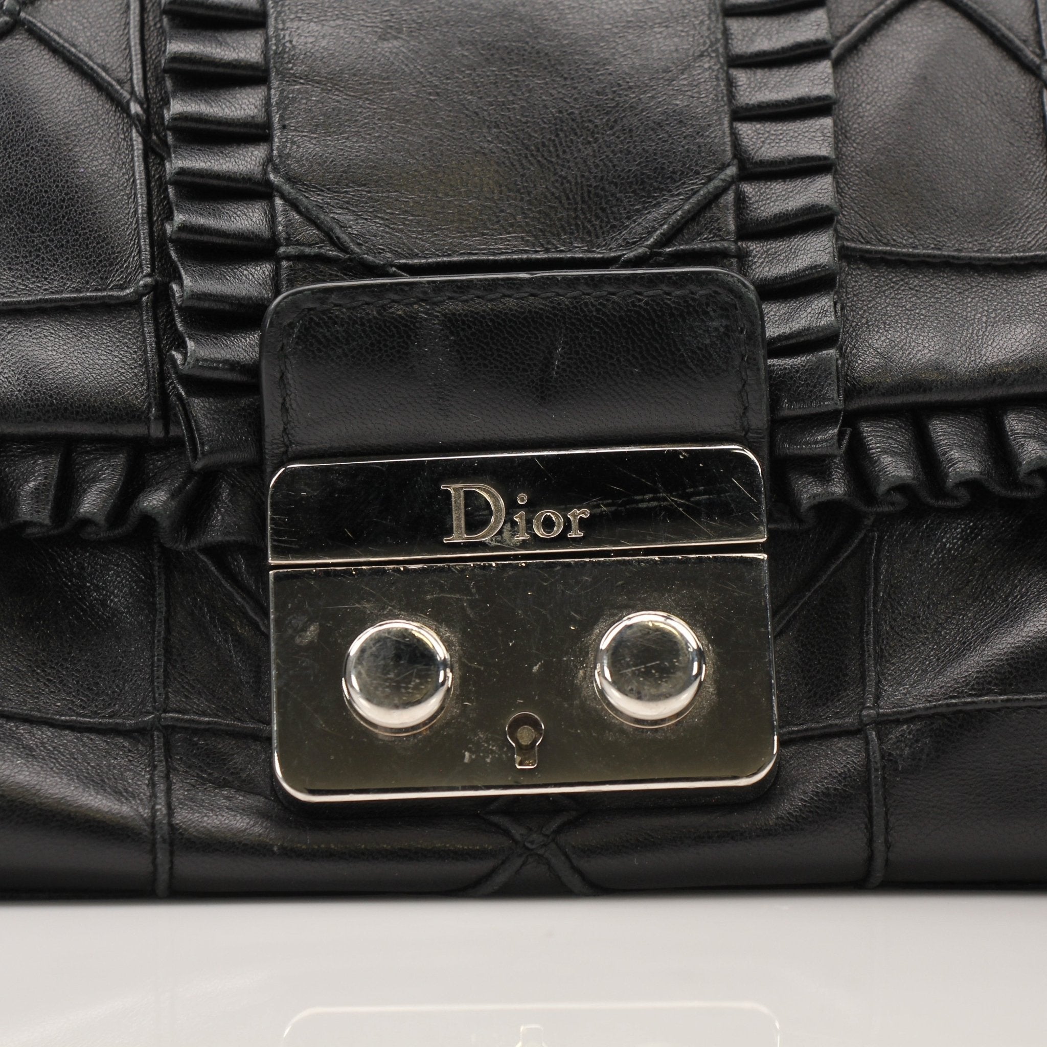 Christian Dior New Lock Ruffle Bag handbag with gold-tone hardware and ruffle detailing, stylish accessory for elegant occasions.