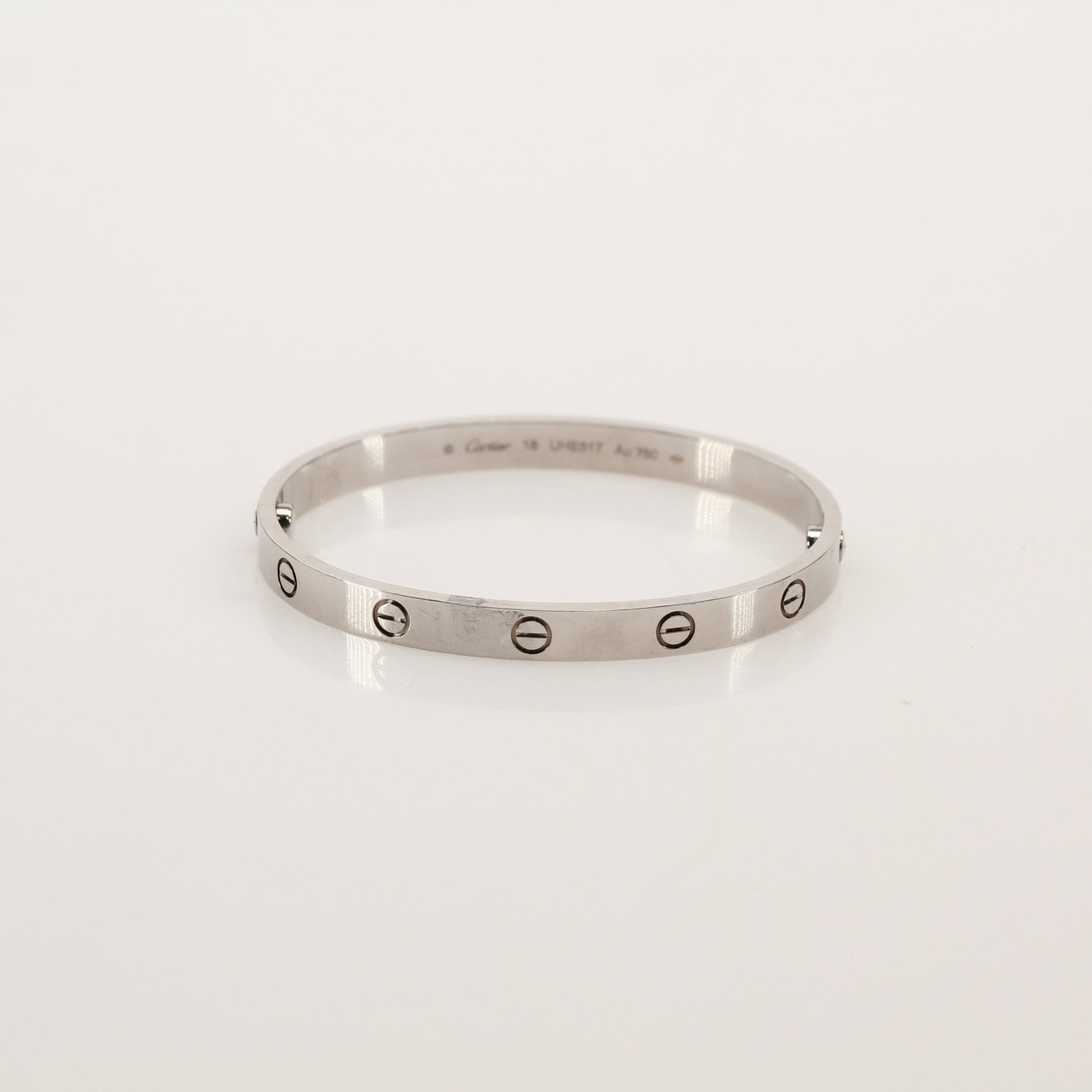 Gold & Beyond Cartier Love bracelet made of gold jewelry featuring the signature screw motif and sleek design.