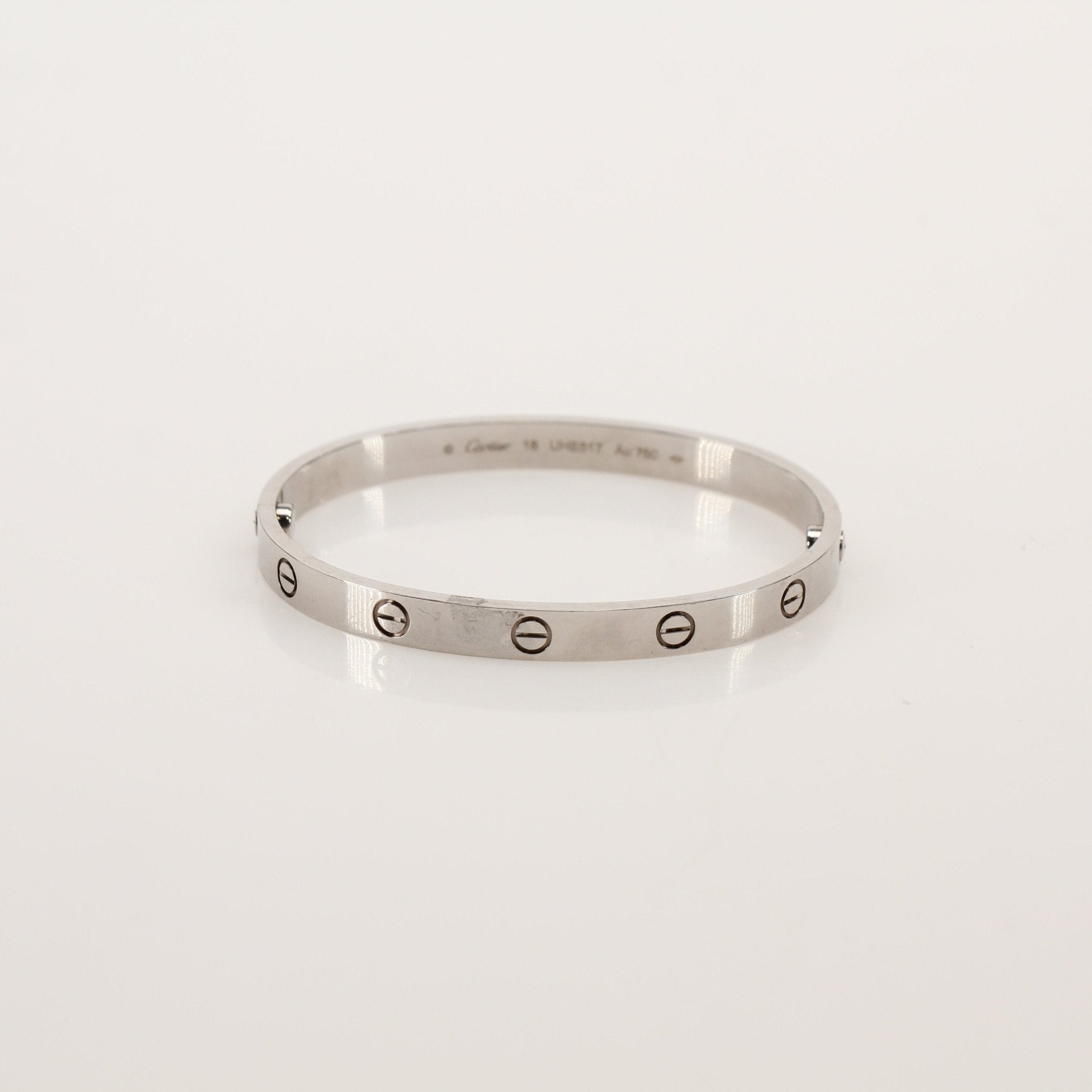 Gold & Beyond Cartier Love bracelet made of gold jewelry featuring the signature screw motif and sleek design.