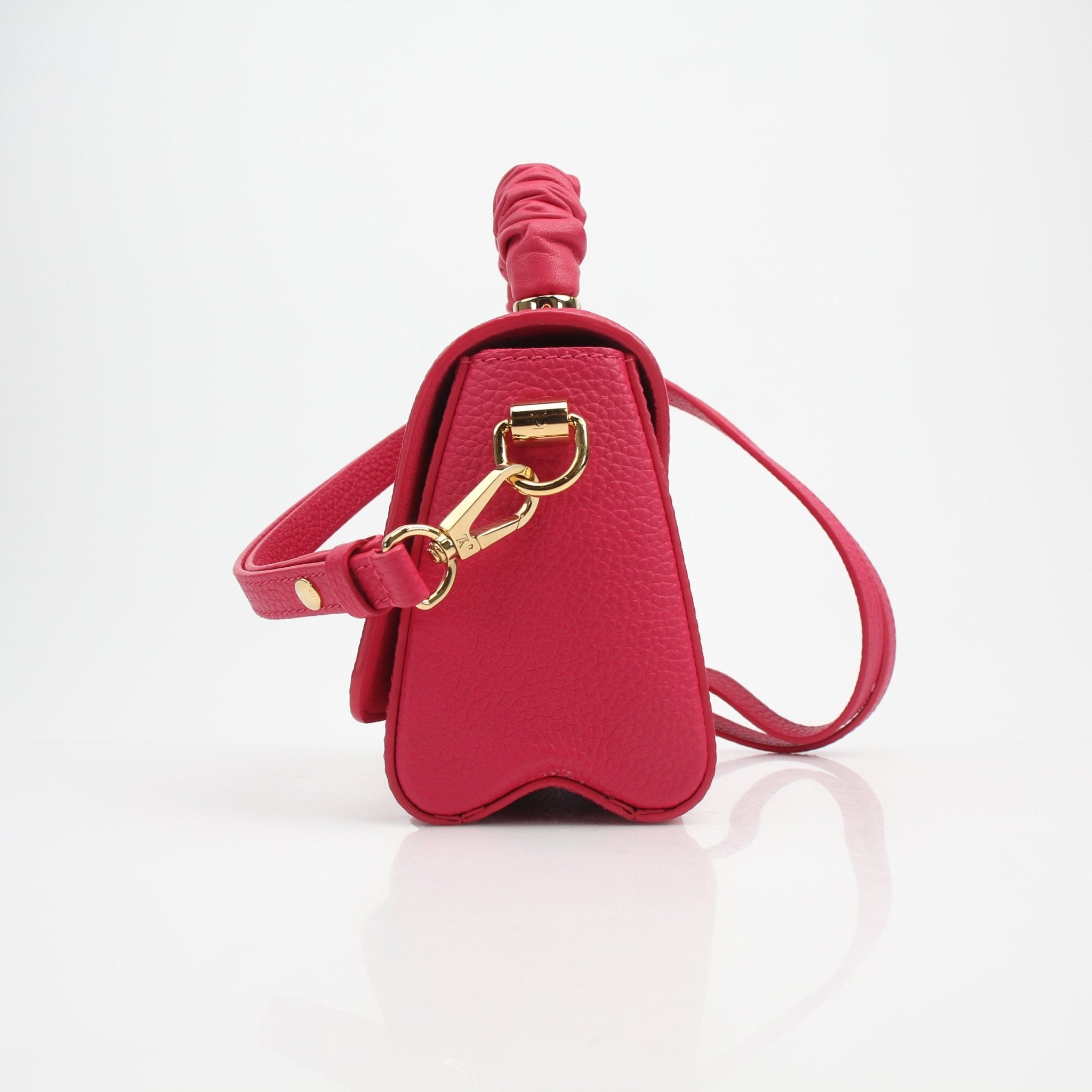 Louis Vuitton Twist One Handle PM handbag in Pondichéry Pink Taurillon leather, featuring a sleek design with a gold-tone clasp.
