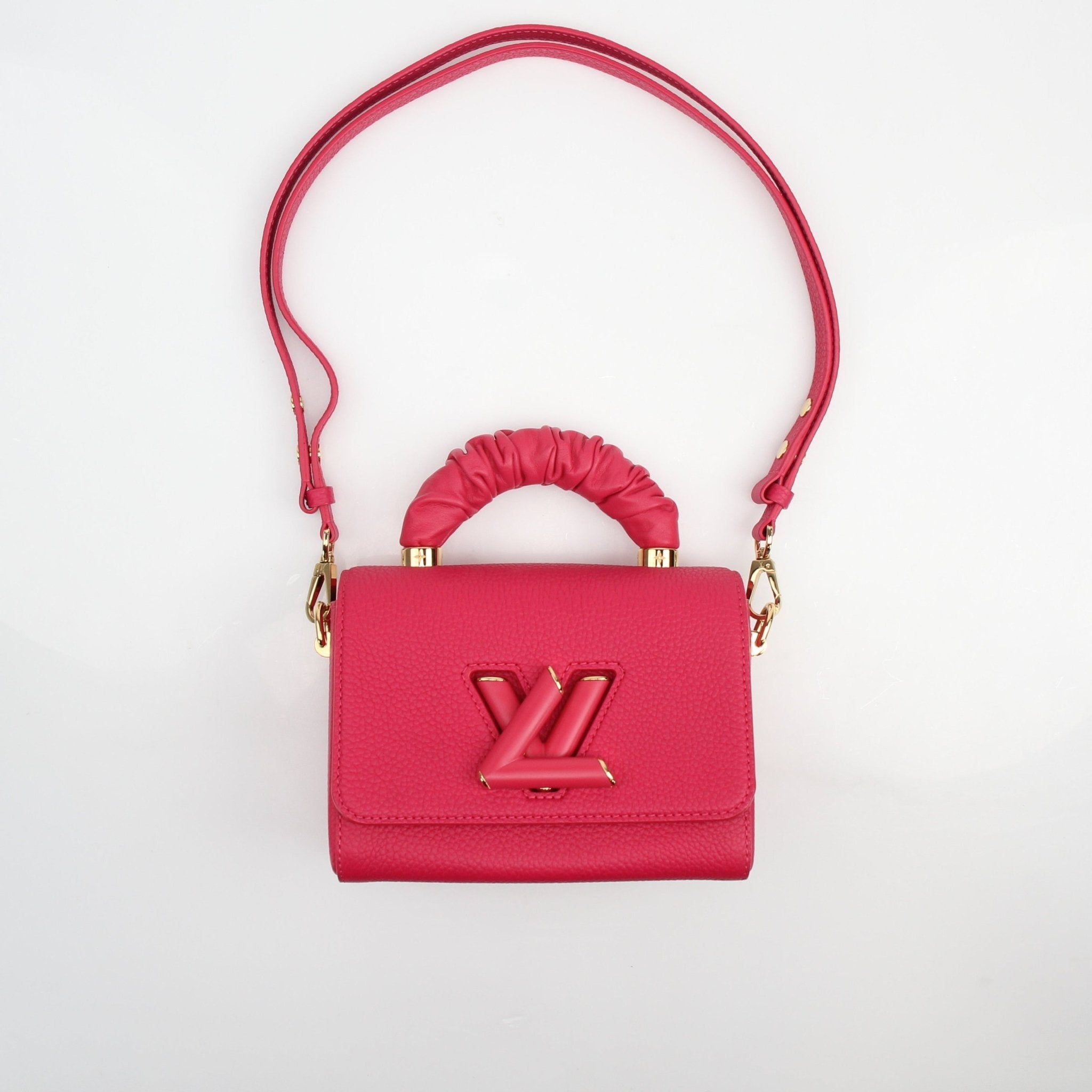 Louis Vuitton Twist One Handle PM handbag in Pondichéry Pink Taurillon leather, featuring a sleek design and gold hardware.