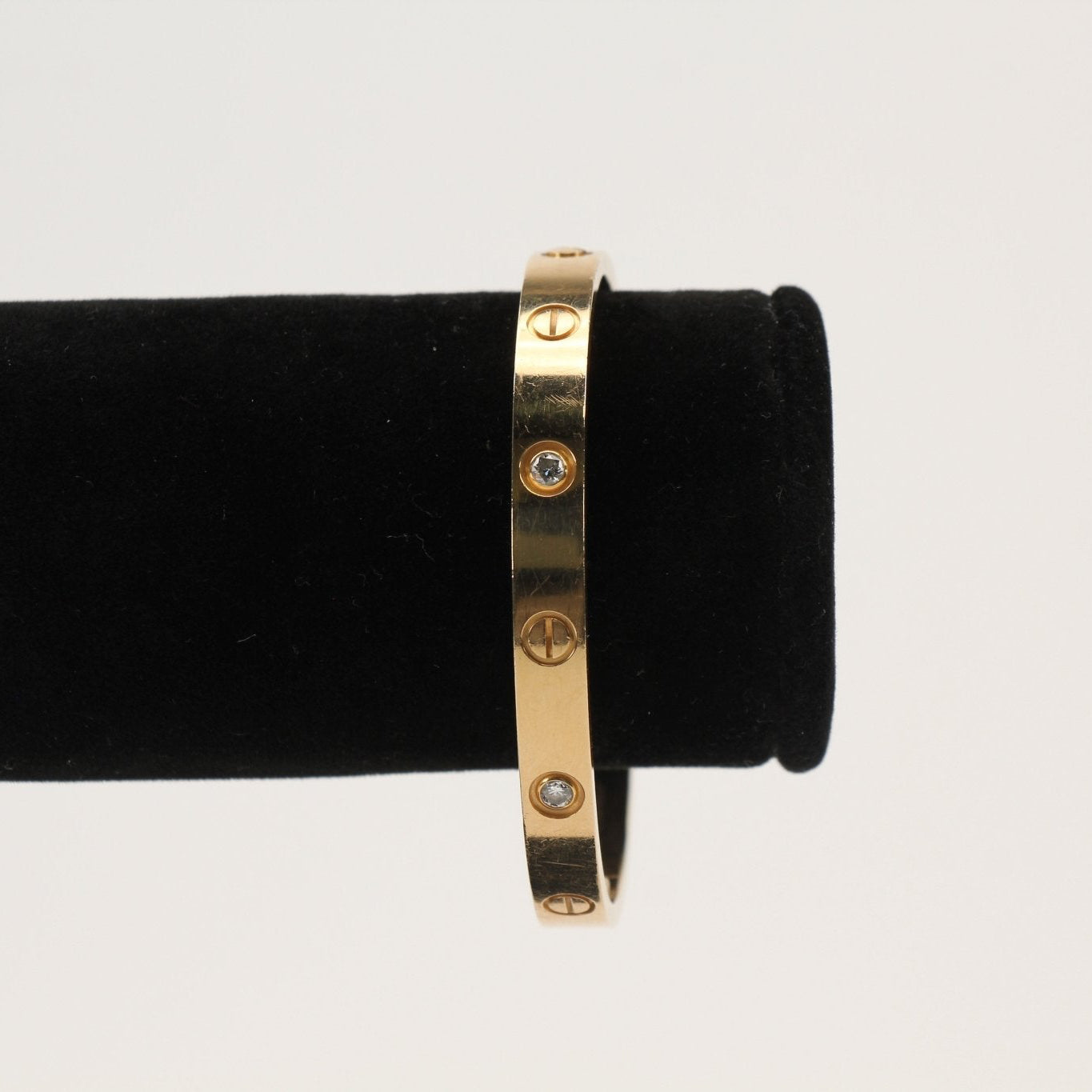 Cartier Diamond Love cuff bracelet featuring gold jewelry design with sparkling diamond accents, stylish and elegant accessory.