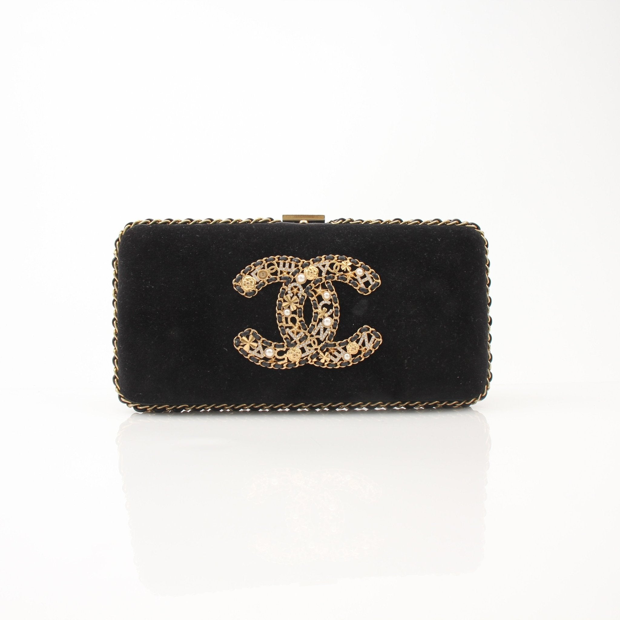 Chanel black velour CC chain evening clutch handbag with gold accents and elegant design.
