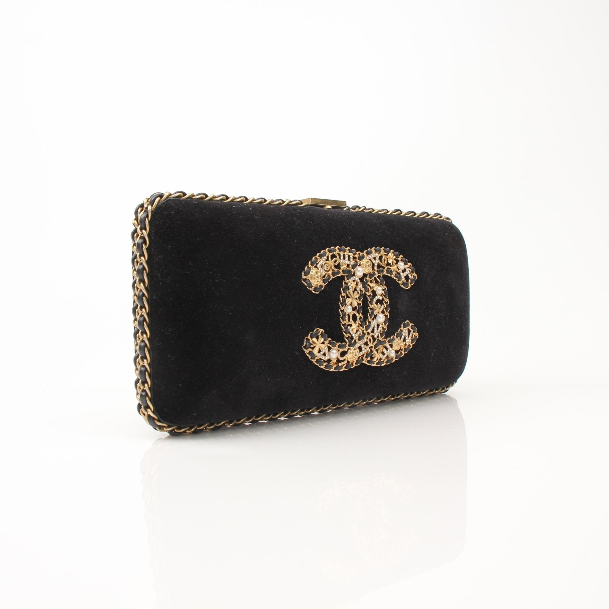 Chanel black velour CC chain evening clutch handbag with gold accents, featuring a classic design and elegant chain strap.