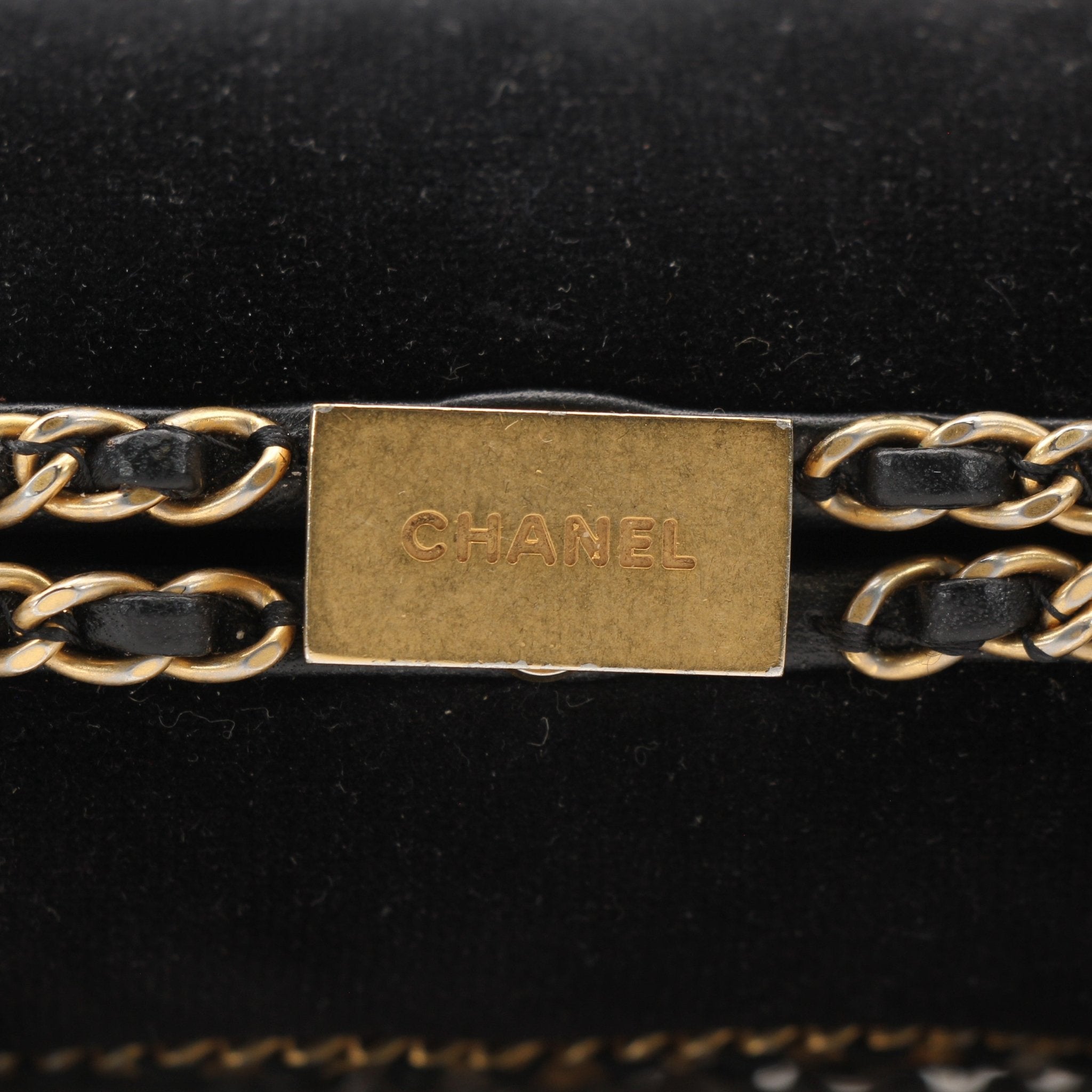Chanel black velour CC chain evening clutch handbag with gold accents and compact design.