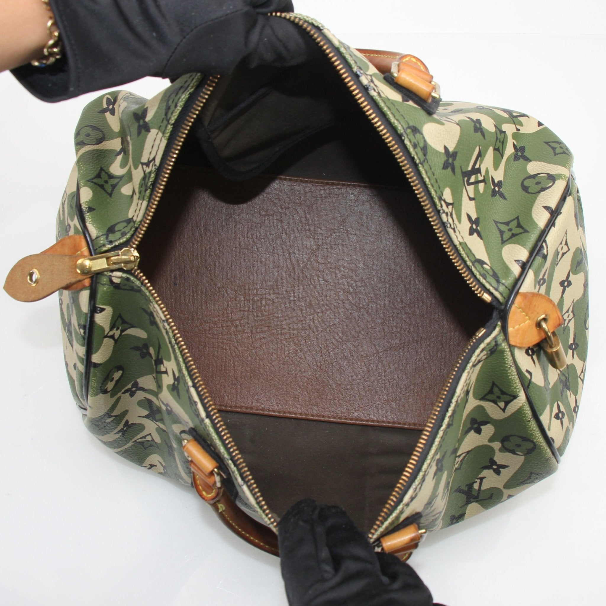 Louis Vuitton x Takashi Murakami Monogramouflage Speedy 35 travel bag with colorful camo pattern and gold-tone hardware.