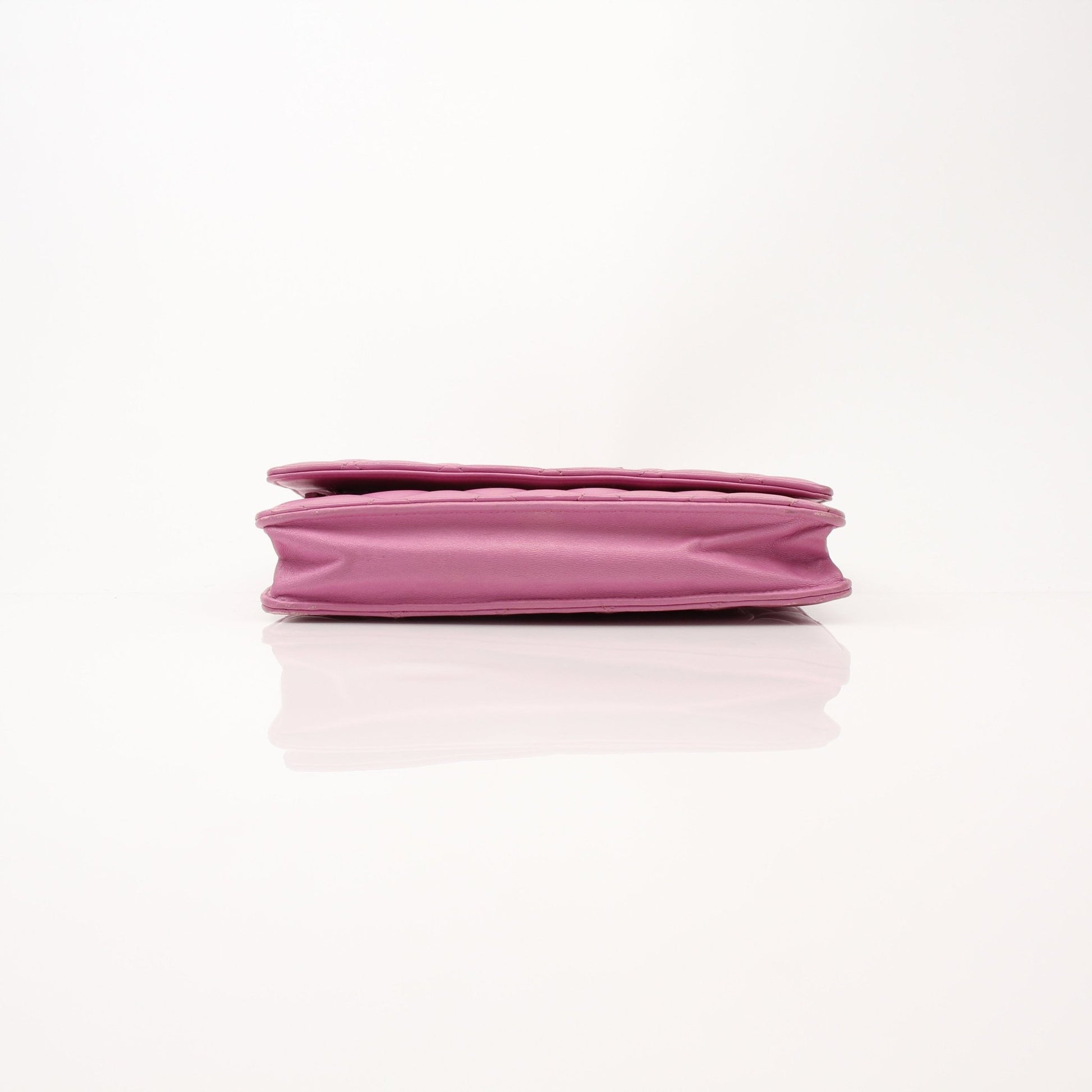 Light purple Chanel wallet on chain with gold accents, featuring a sleek design and compact size for stylish everyday use.