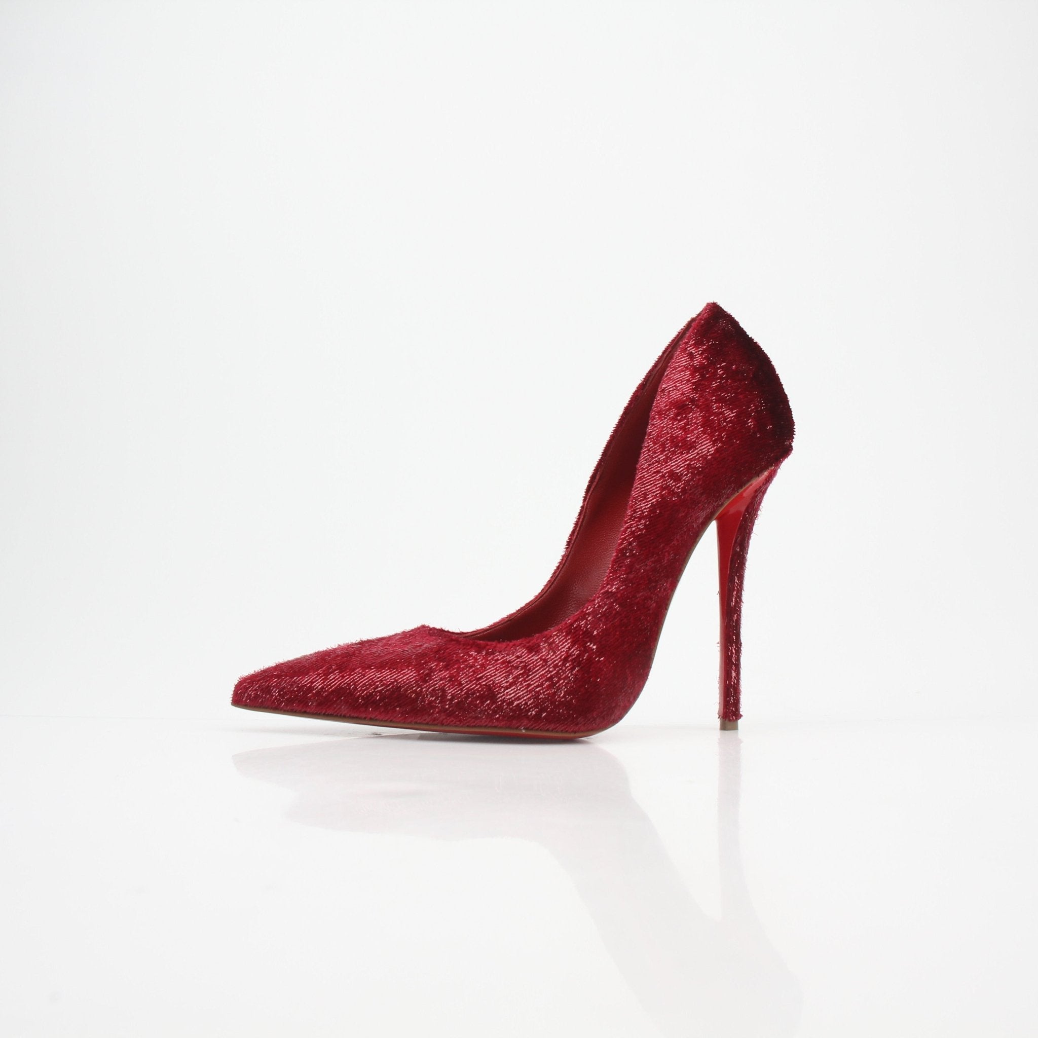 Christian Louboutin Miss Z Velvet Glitter Pumps in red with stiletto heels, showcasing luxurious velvet and sparkling glitter details.