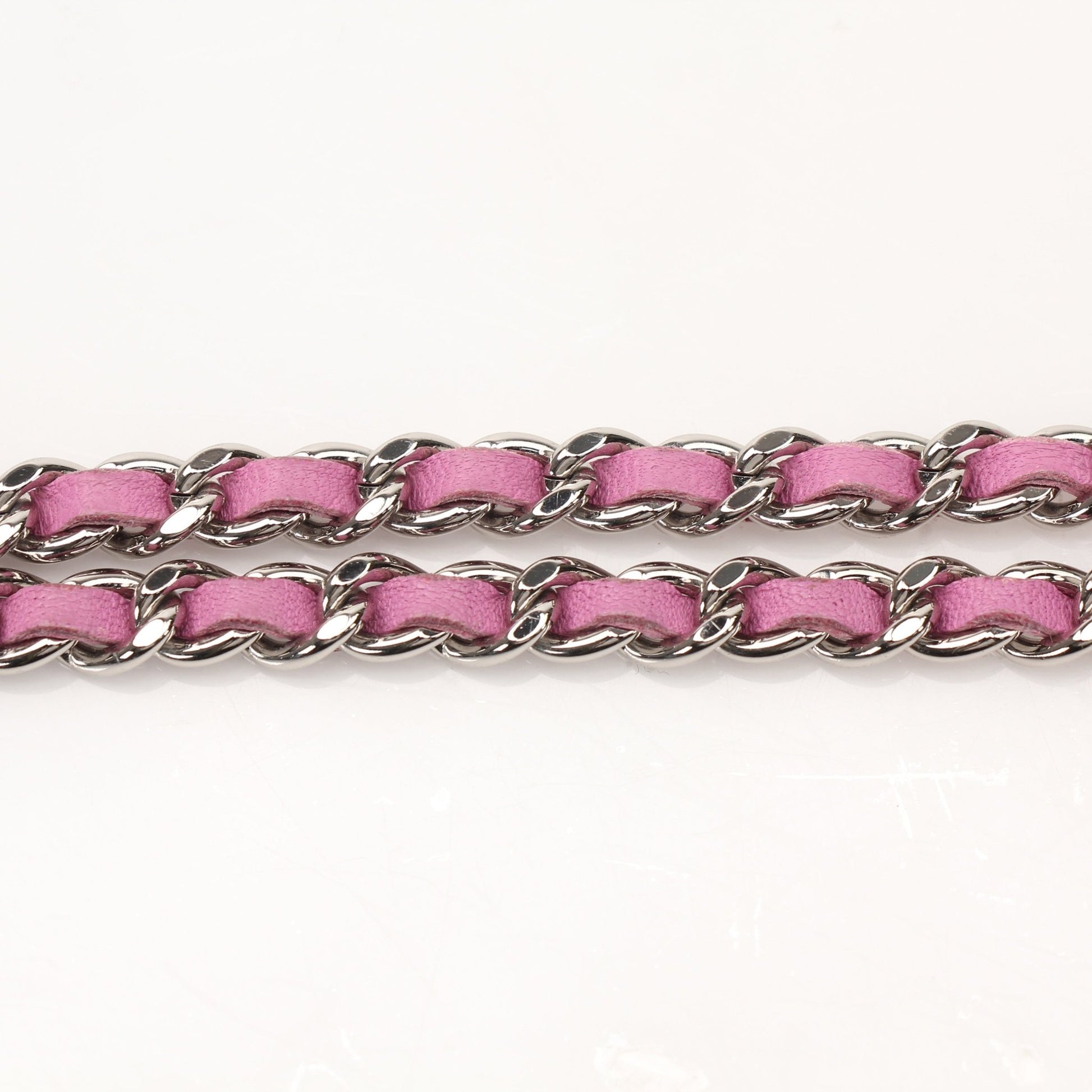 Light purple Chanel wallet on chain with gold hardware, featuring a sleek, compact design and quilted pattern.