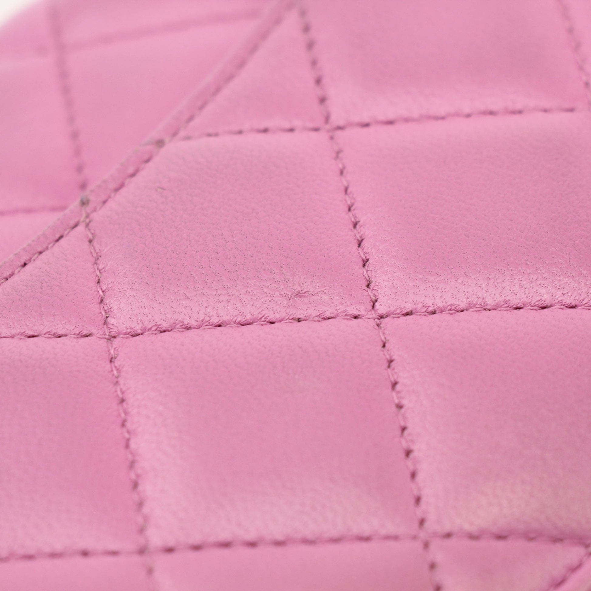 Light purple Chanel wallet on chain with gold hardware, featuring quilted leather and chain strap for stylish carrying.