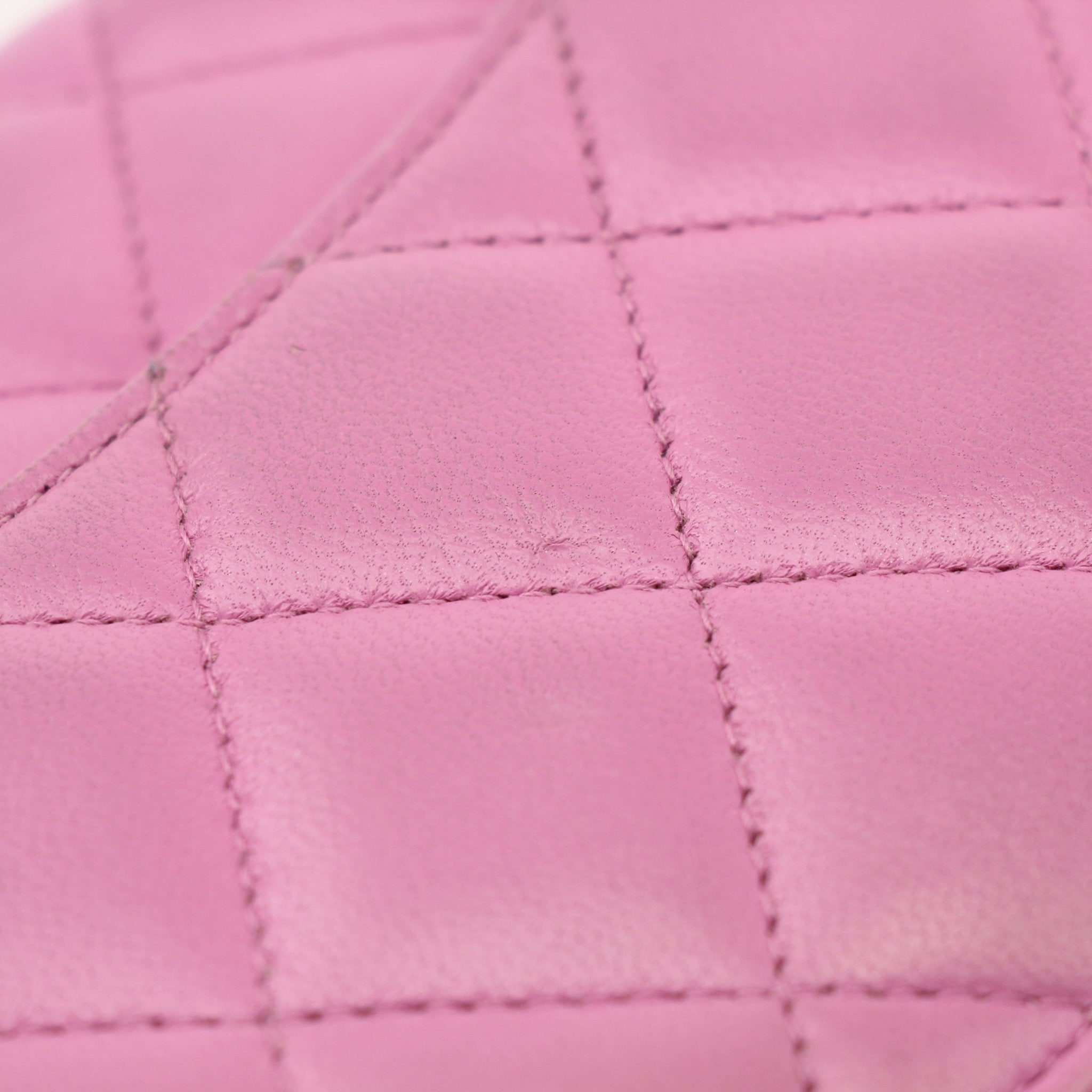 Light purple Chanel wallet on chain with gold hardware, featuring quilted leather and chain strap for stylish carrying.