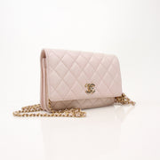 Gold & Beyond Chanel blush pink wallet on chain with gold hardware, featuring a sleek, compact design and multiple card slots.