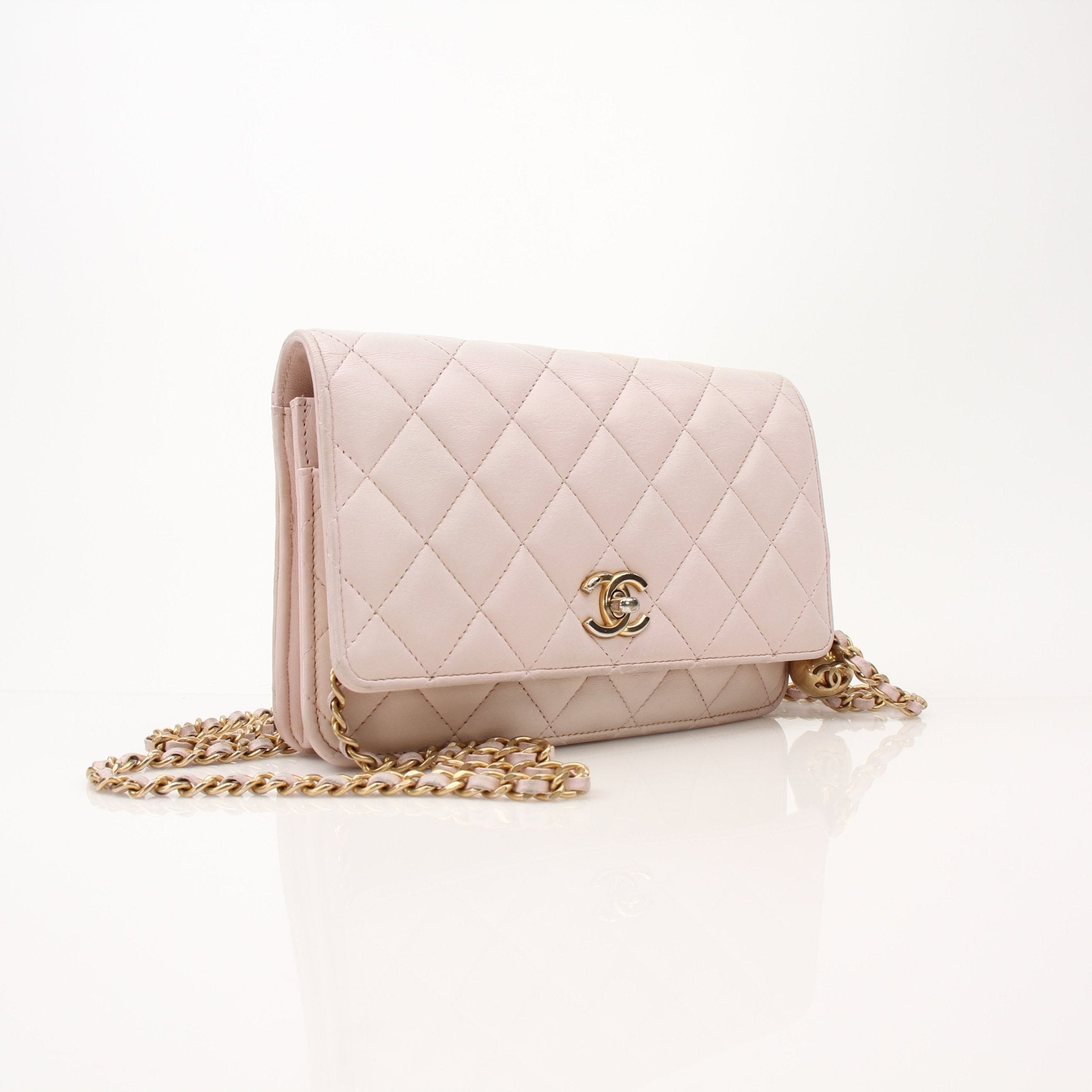 Gold & Beyond Chanel blush pink wallet on chain with gold hardware, featuring a sleek, compact design and multiple card slots.