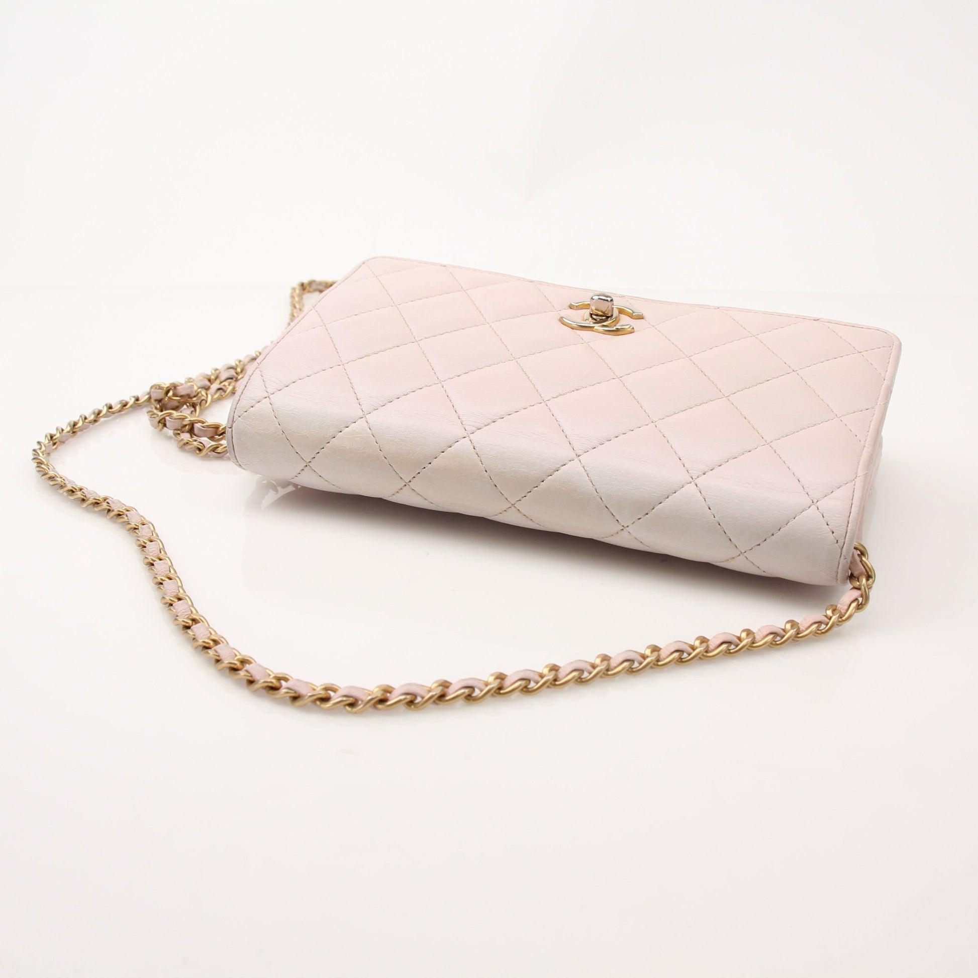 Gold & Beyond Chanel blush pink wallet on chain with gold hardware, compact design, and textured leather finish.