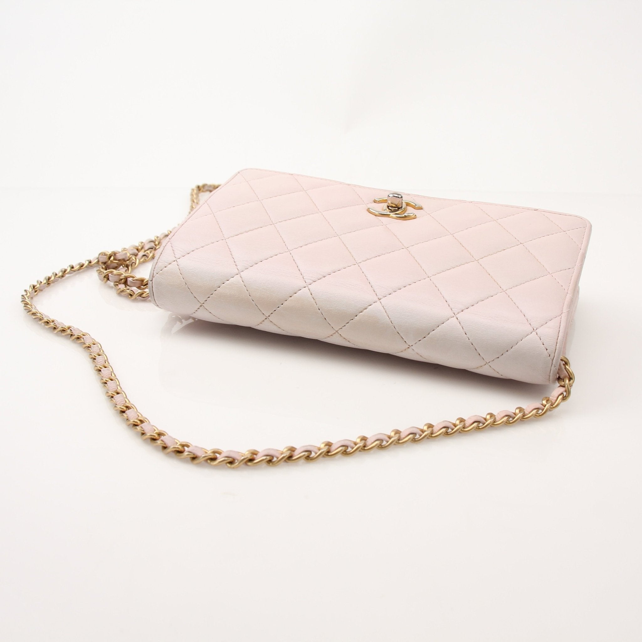 Gold & Beyond Chanel blush pink wallet on chain with gold hardware, compact design, and textured leather finish.