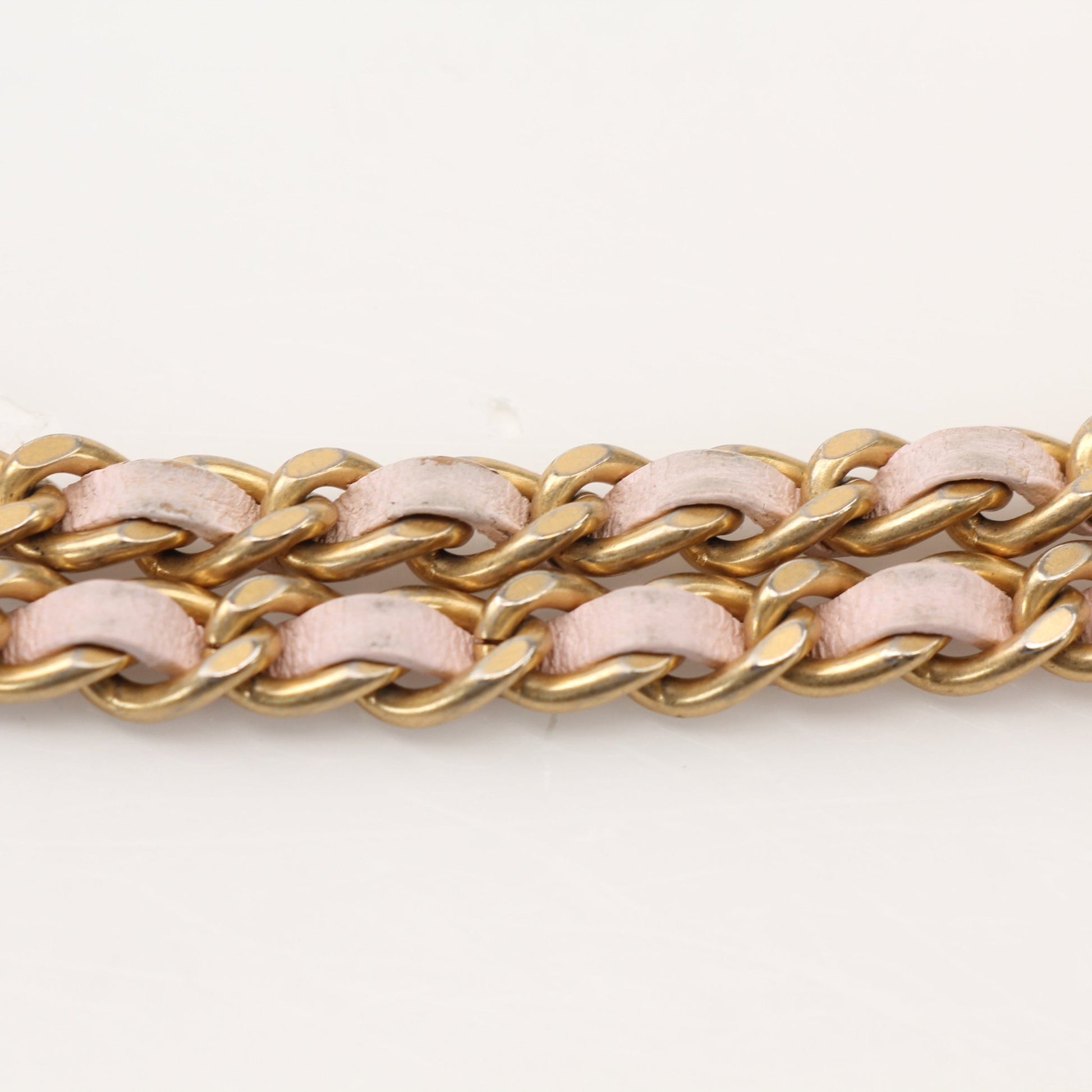 Gold & Beyond blush pink Chanel wallet on chain showing the compact wallet with chain strap and quilted leather detail.