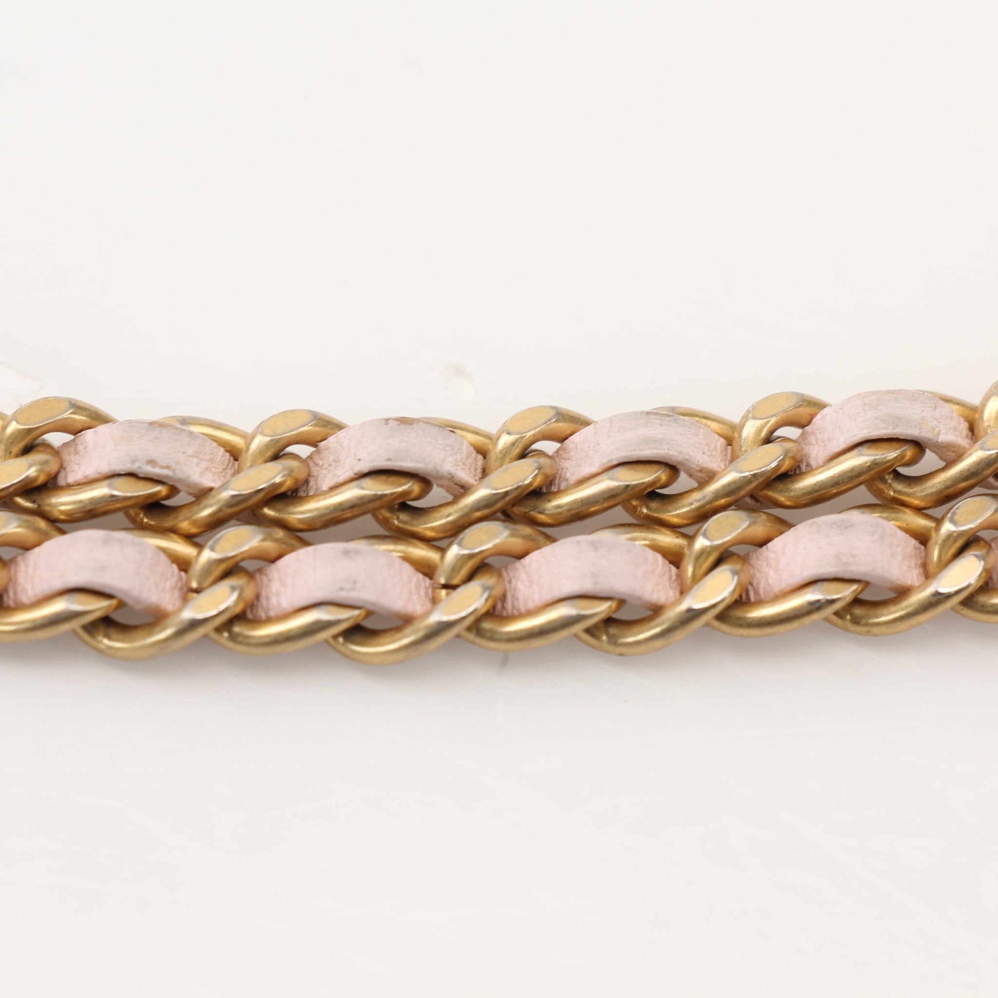 Gold & Beyond blush pink Chanel wallet on chain showing the compact wallet with chain strap and quilted leather detail.