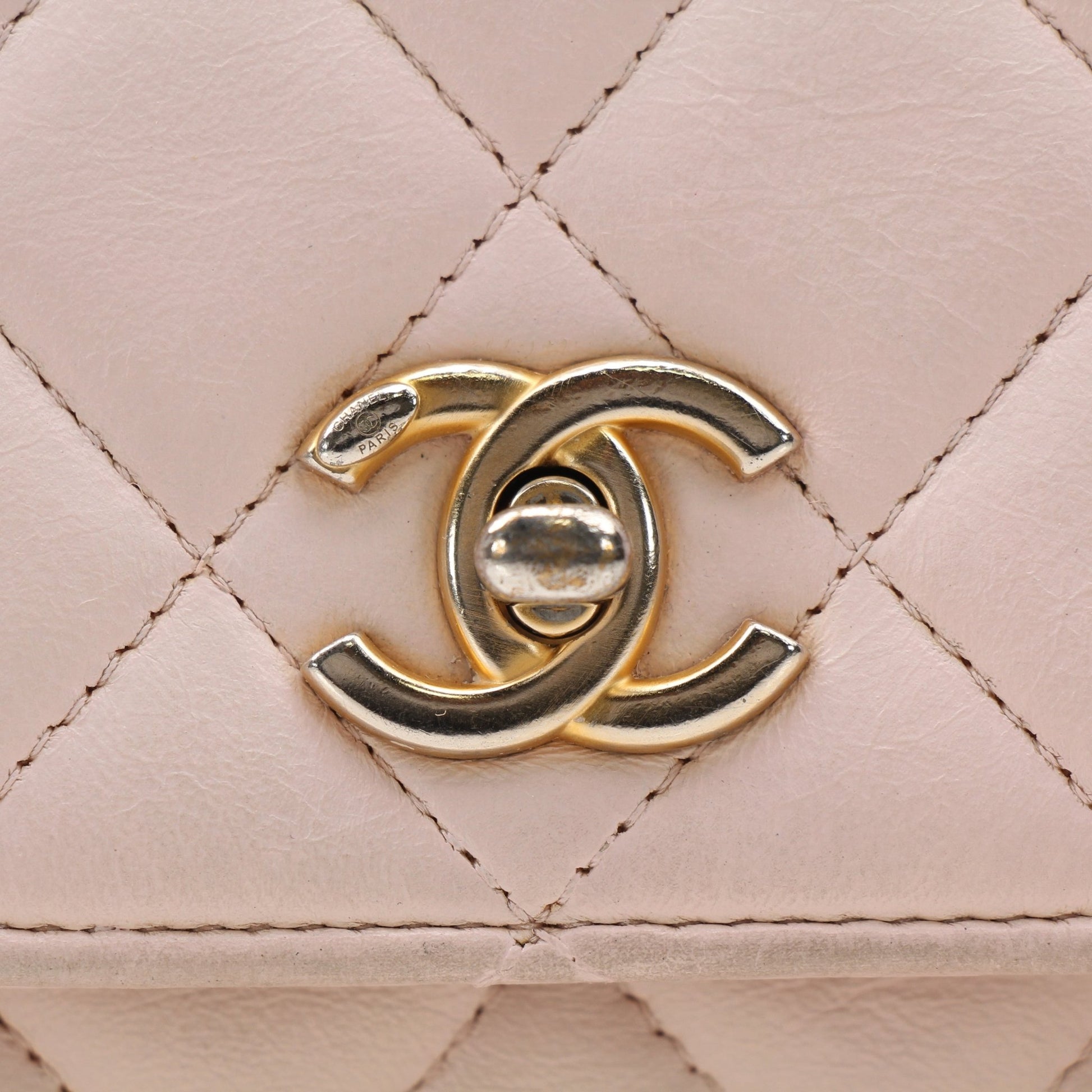 Gold & Beyond pink Chanel wallet on chain with gold hardware, featuring a blush pink leather wallet and chain strap.