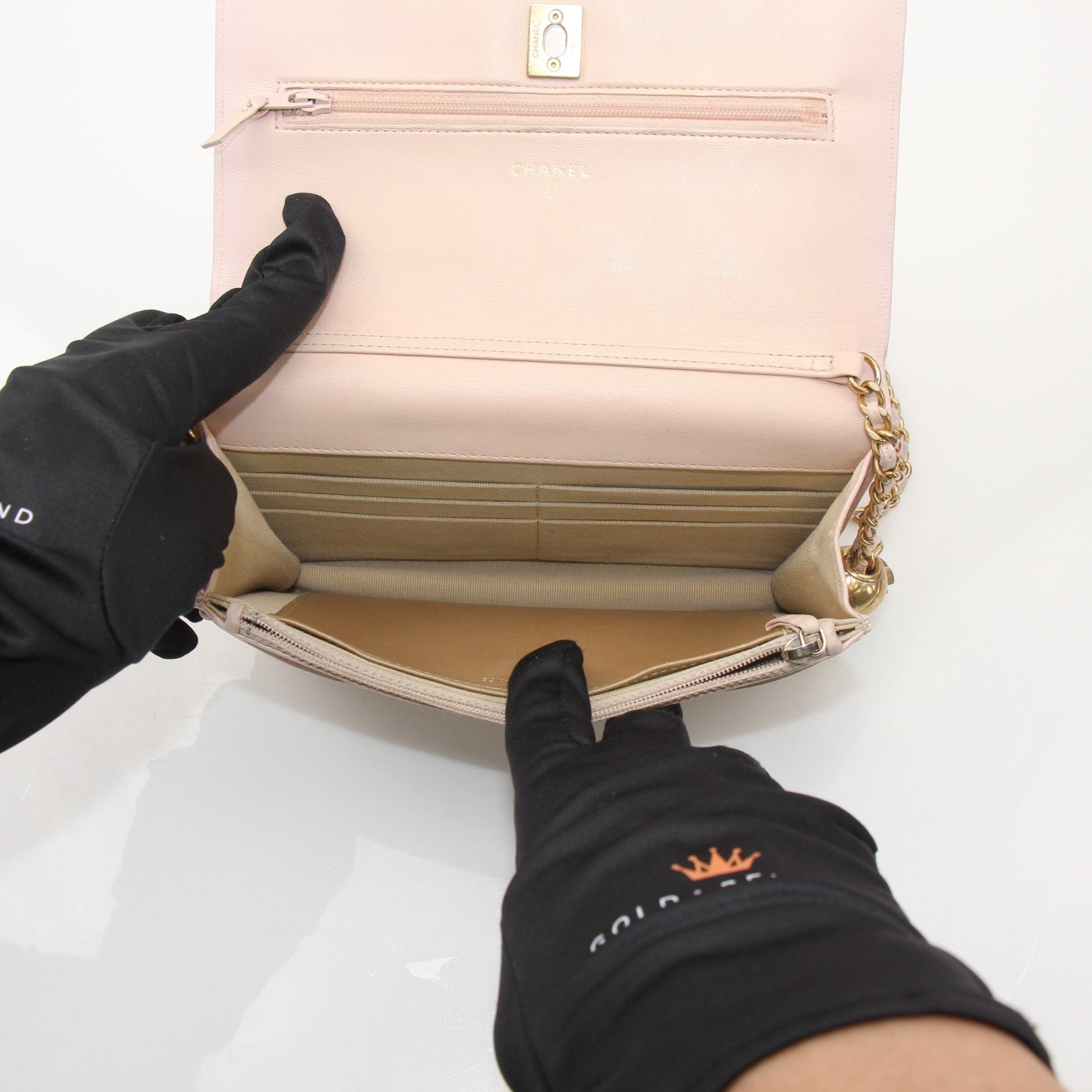 Gold & Beyond blush pink wallet on chain with quilted leather and gold-tone chain strap, featuring a compact and elegant design.
