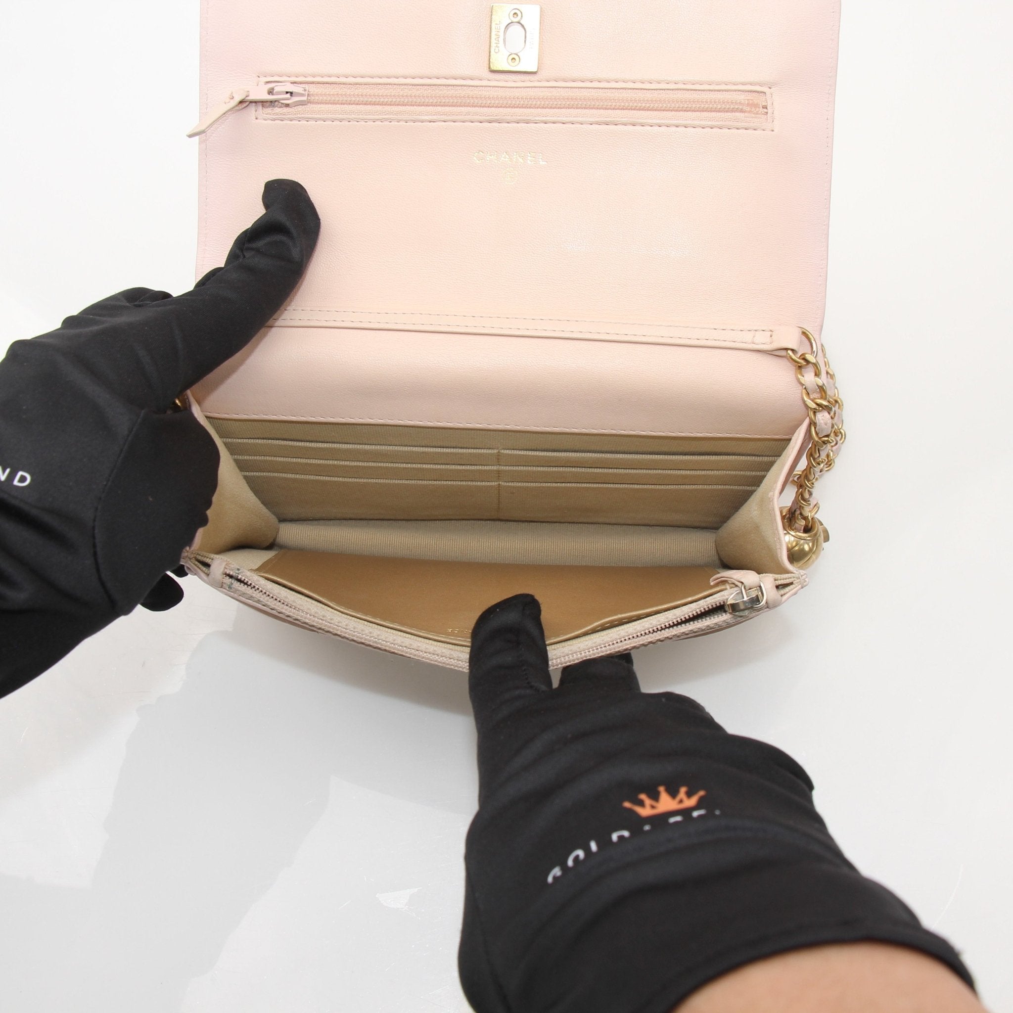 Gold & Beyond blush pink wallet on chain with quilted leather and gold-tone chain strap, featuring a compact and elegant design.