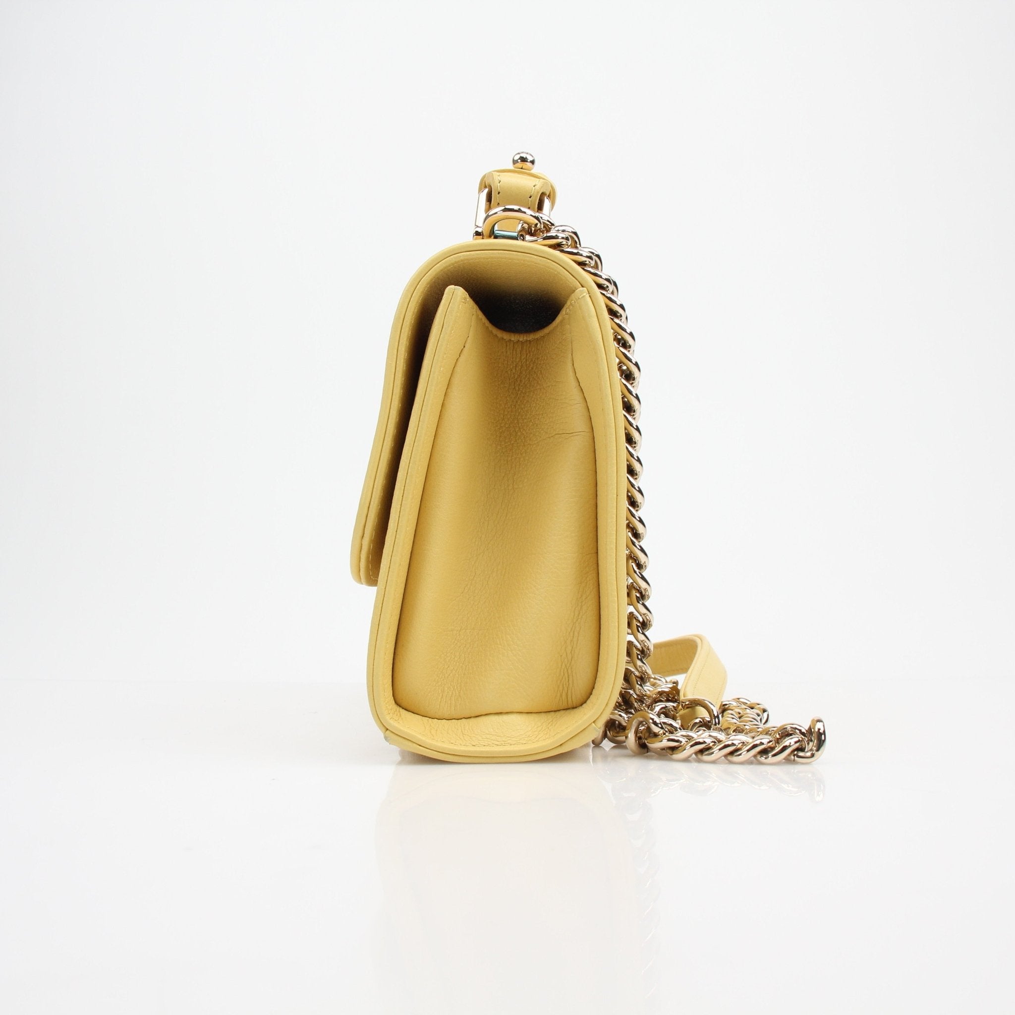 Gold & Beyond yellow quilted calfskin handbag with top handle and flap closure, featuring a luxurious Chanel-inspired design.