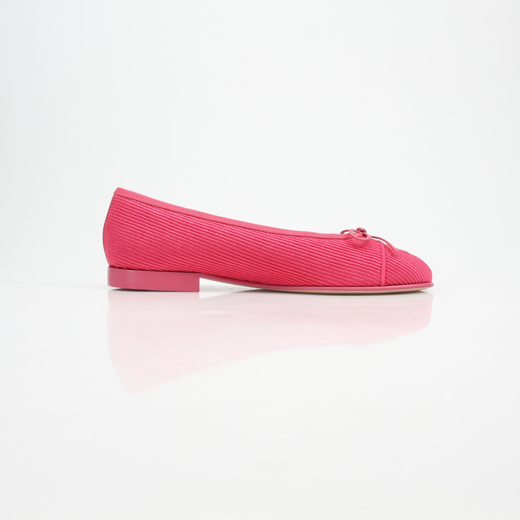 Pink corduroy Chanel CC bow ballerina flats by Gold & Beyond, showcasing elegant slip-on shoes with bow detail and classic design.